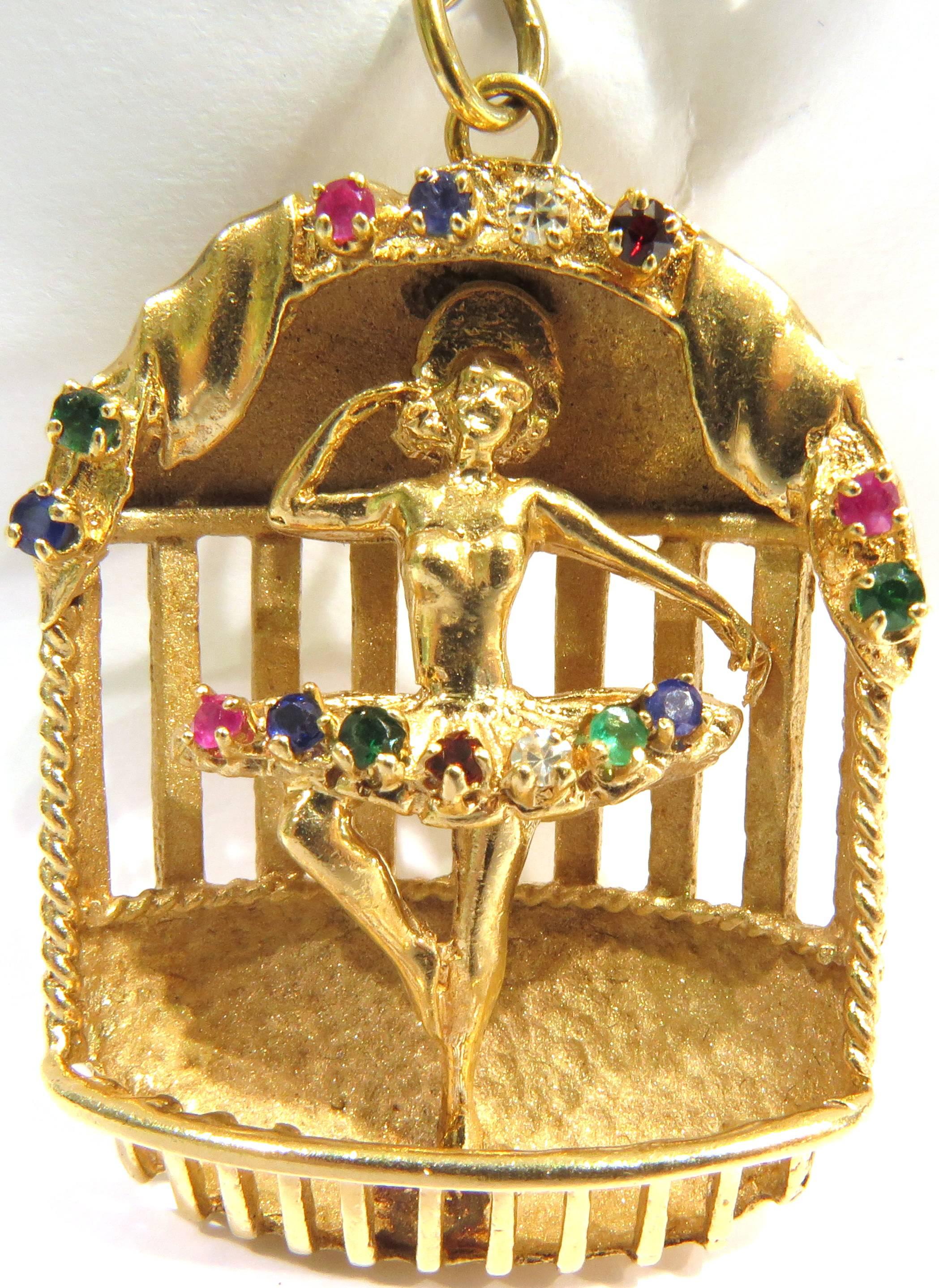This ballerina charm is set in 14k yellow gold with diamonds rubies sapphires emeralds garnets and green toumalines. This graceful ballerina seems to be on stage.
This charm weighs 17.70 grams
This charm measures 1 9/16 inch high by 1 1/4 in across