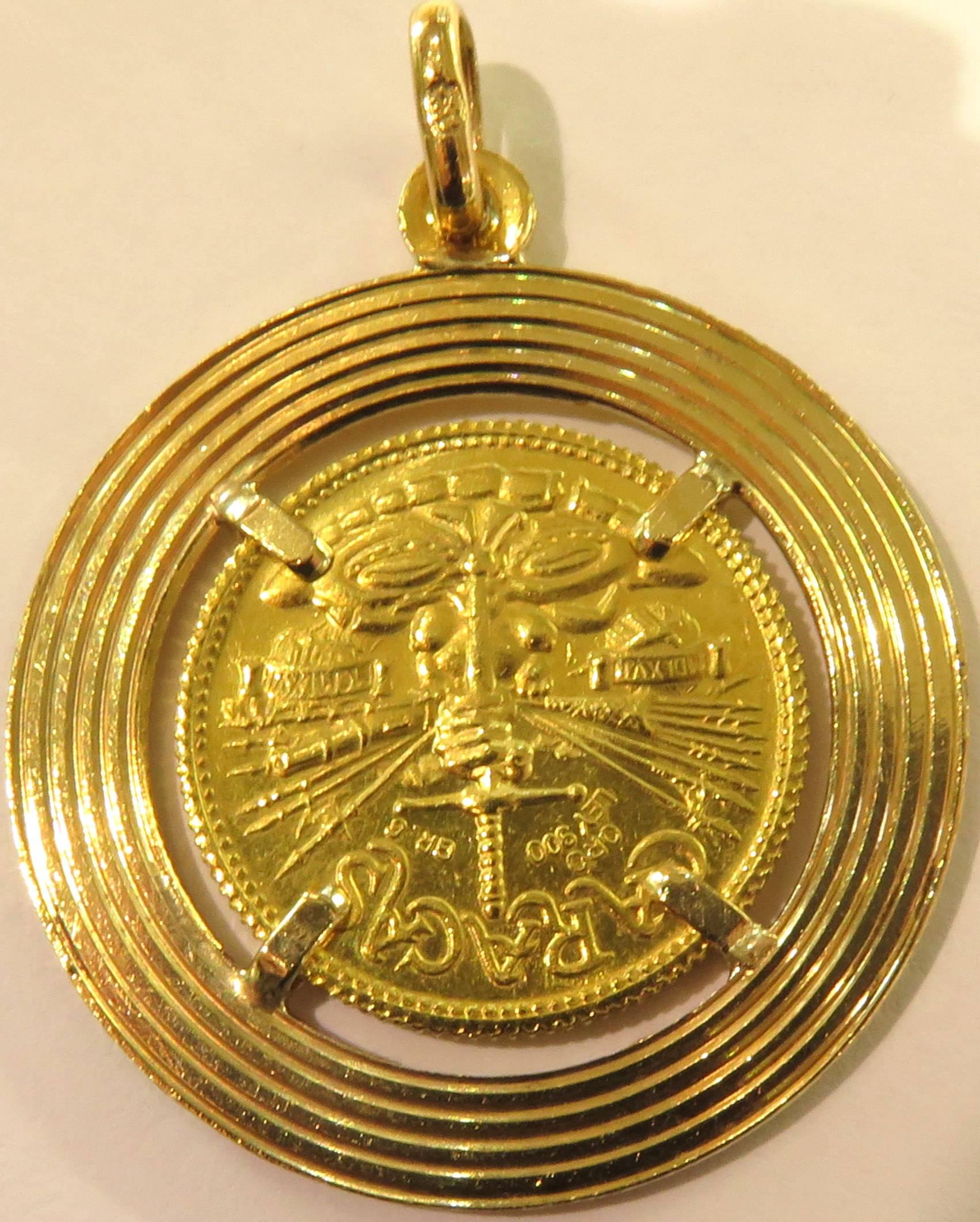 This 22k carat coin is mounted in a 18k ridged record looking disk. 
Including attached bale, this charm/pendant measures 1 9/16 inch high by 1 1/4 inch across.
This charm pendant weighs 11.3 grams
