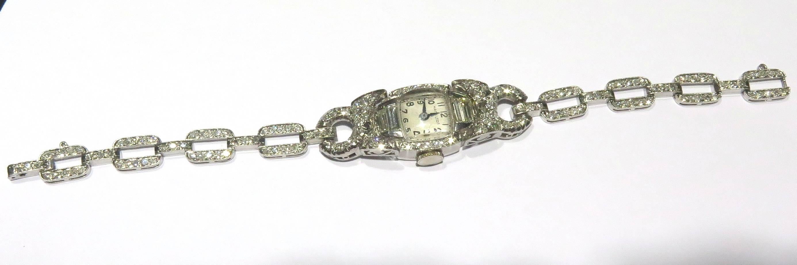 This Hamilton Art Deco watch is a classic! 
This watch is all platinum marked 10% irid Plat.
There are approx 2.50ct diamonds
This watch weighs 23 grams
This watch is approx 6 7/16 inch long