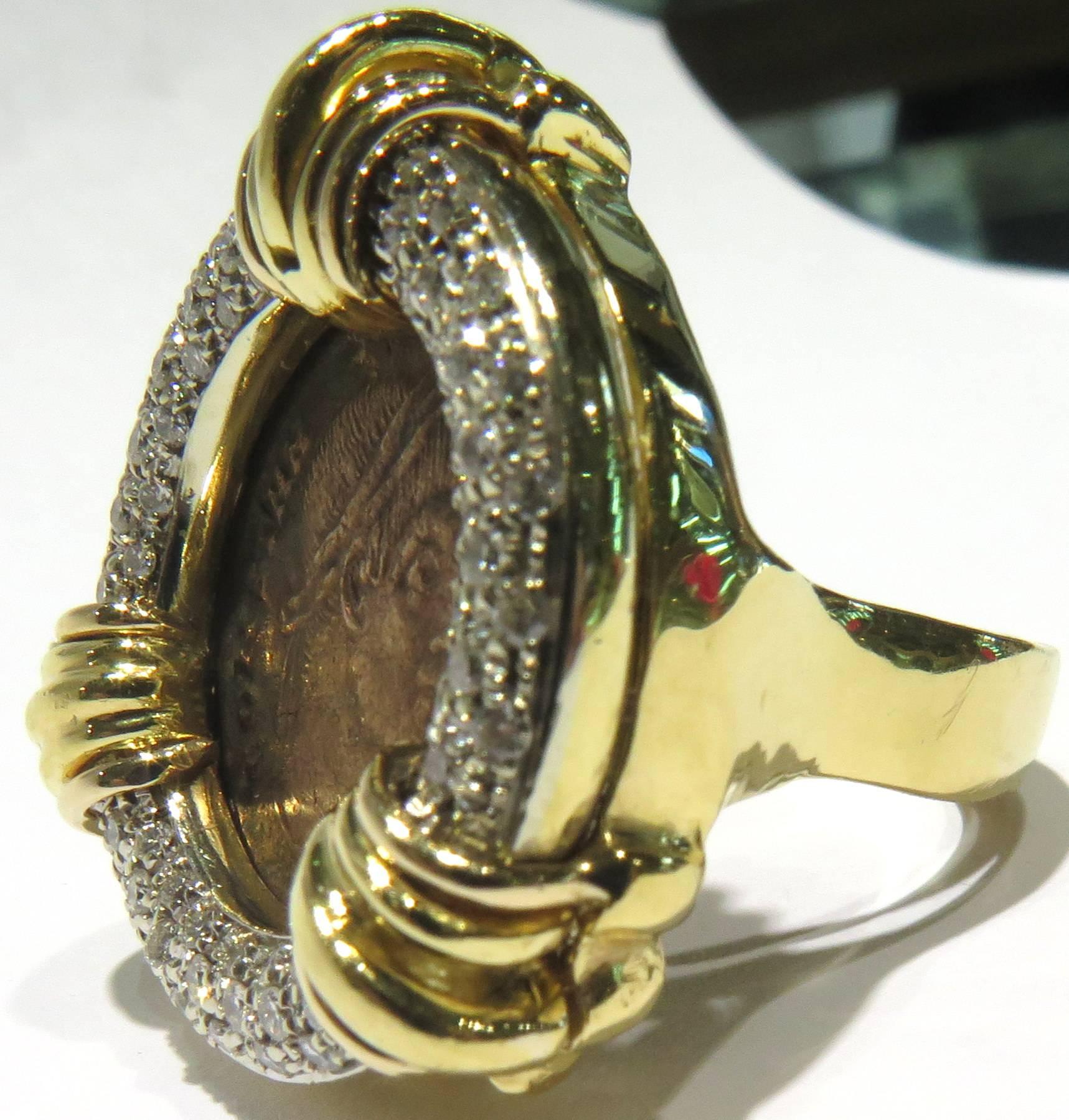 This amazing ring is a real show stopper. The oversized diamond tubular bezel adds to the dramatic effect of the ancient bronze coin. This ring is set in 18k yellow and white gold. The previous owner had a butterfly seizer put in for a working