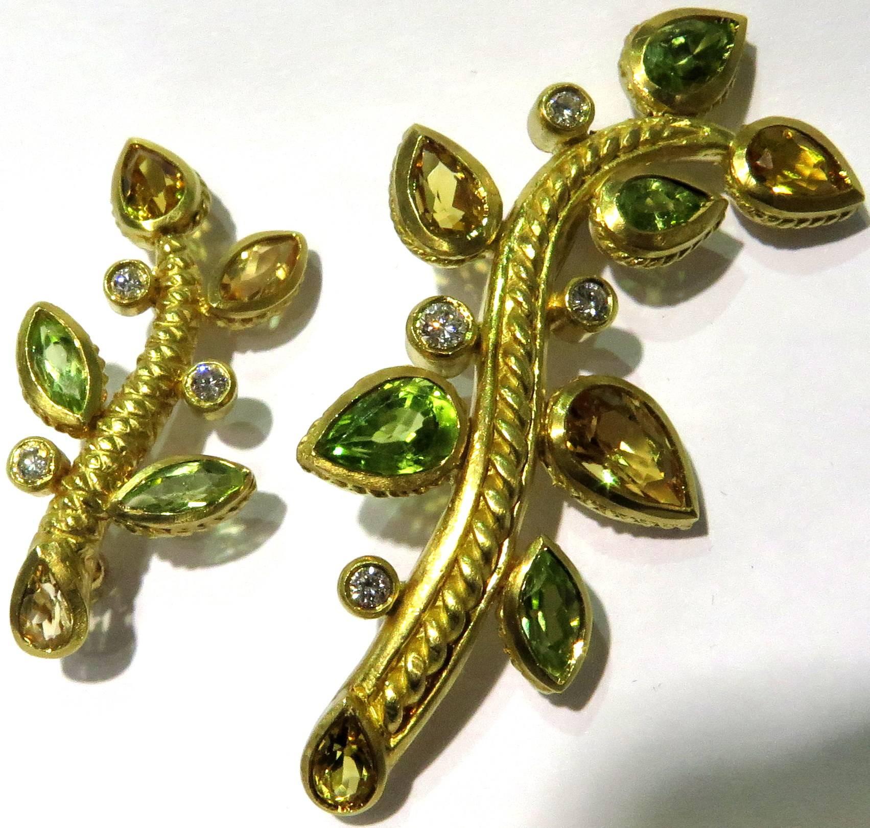 These 2 pins by Judith Ripka are in 18k yellow gold. They are both in a branch motif with yellow beryls and peridots, accented with diamonds. 
The smaller pin measures 1 3/8 inch high by 5/8 inch wide.
The larger pin measures 2 inches high by 1 inch