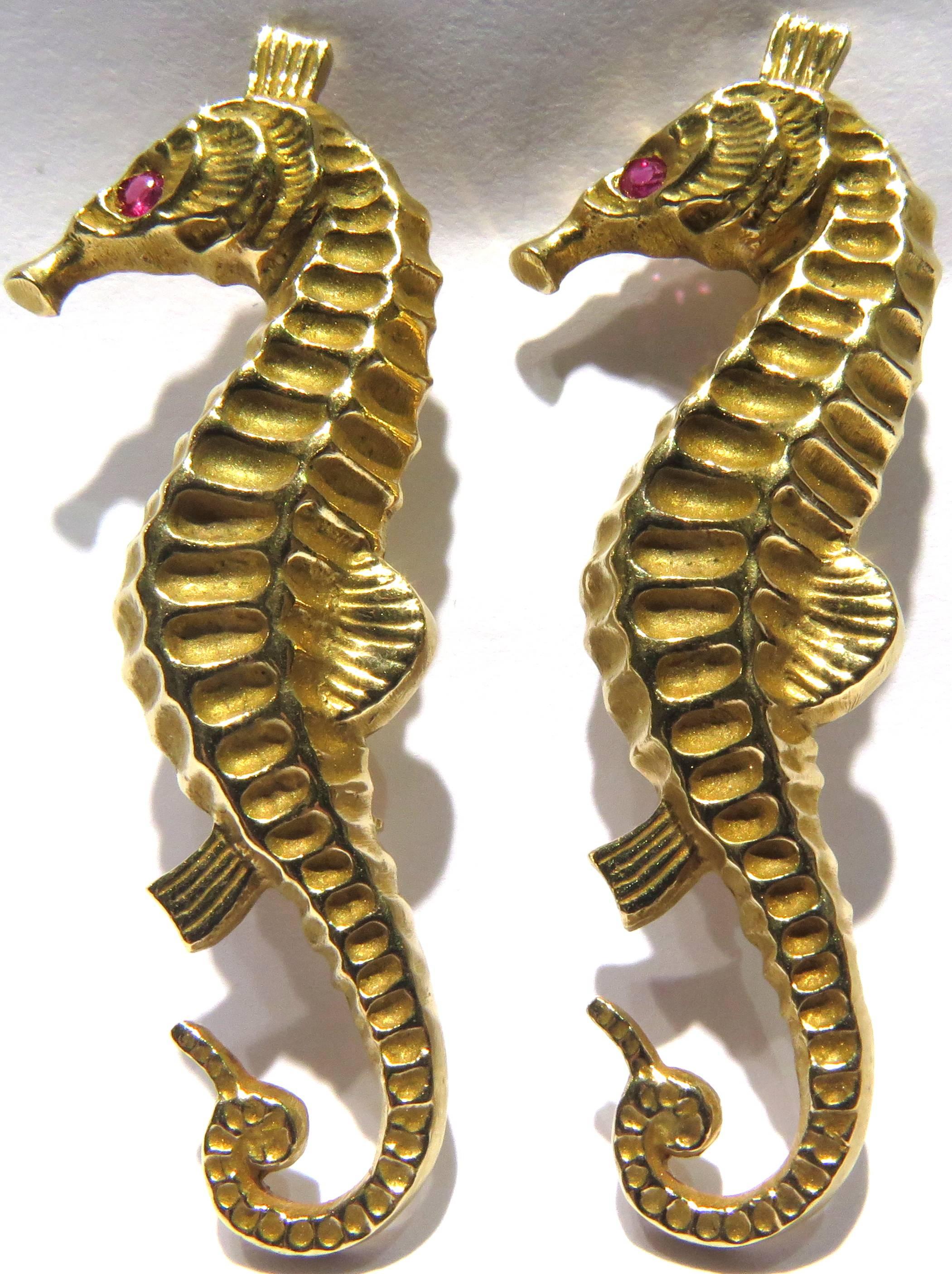 This pair of incredibly detailed 14k gold seahorses are so realistic, they are like a sculpture. They are both the same size. Each features 1 faceted ruby eye.
These pins weigh 14.2 grams
Each of the pins separately measure 2 inches high by 2/3 inch