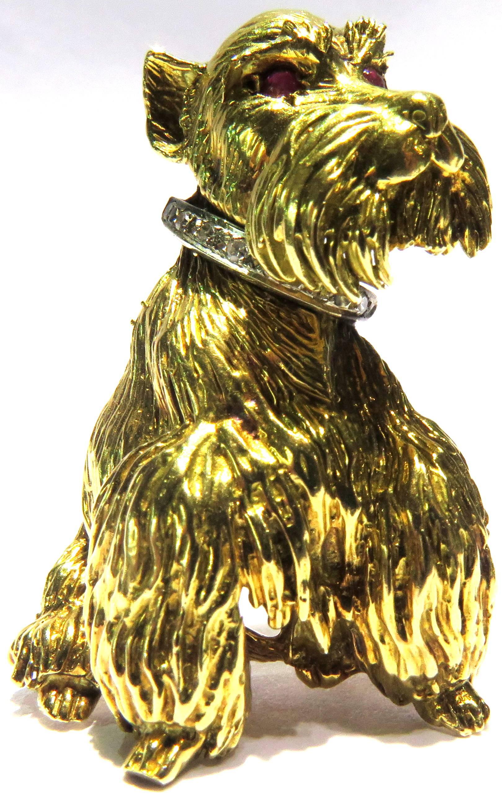 This adorable 18k gold dog pin is signed JK. His eyes are cabochon rubies and he wears a white gold diamond collar around that oh so handsome neck. 
This pin measures 1 3/4 inch high by 1 inch across
This pin weighs 18 grams