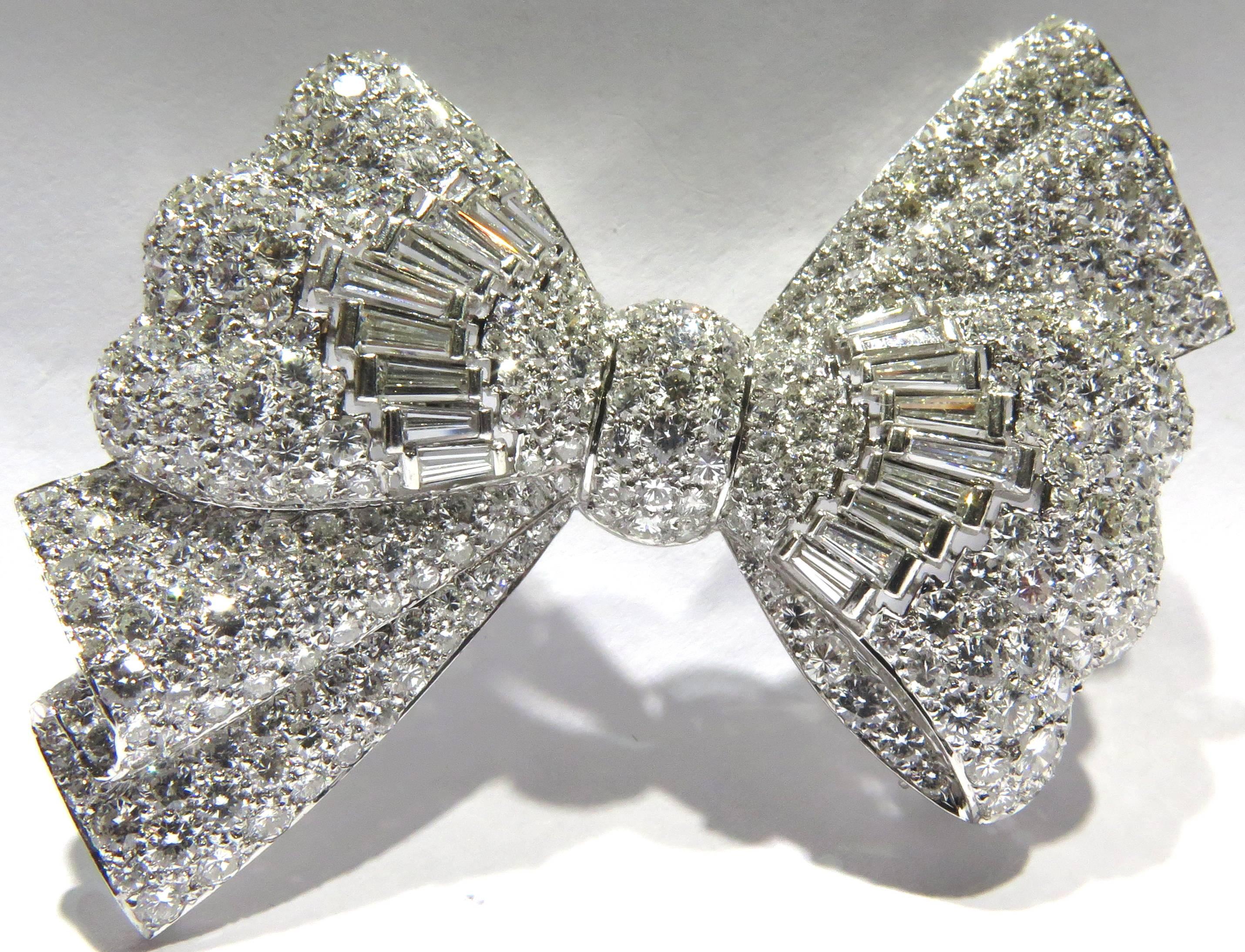 This very beautifully made platinum diamond bow pin contains approx 7.50 carats of diamonds. It is easy to dress up or dress down. We are very privileged to have received this pin from an elegant Palm Beach lady.  There are markings on the reverse