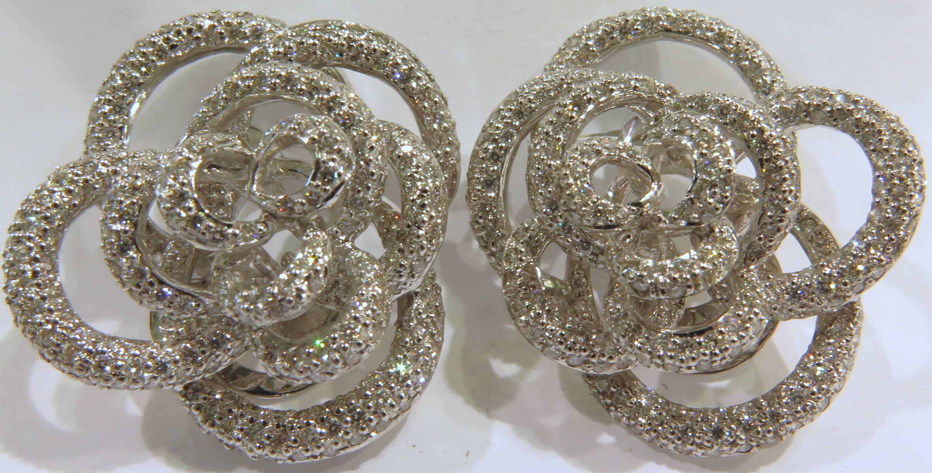 18k white gold rose motif earrings with 3.19ct diamonds. They have lever backs with posts. They are marked 750 for 18k.
These earrings weigh 22.1 grams.
These earrings at the widest are approx 1 1/8 inch 
