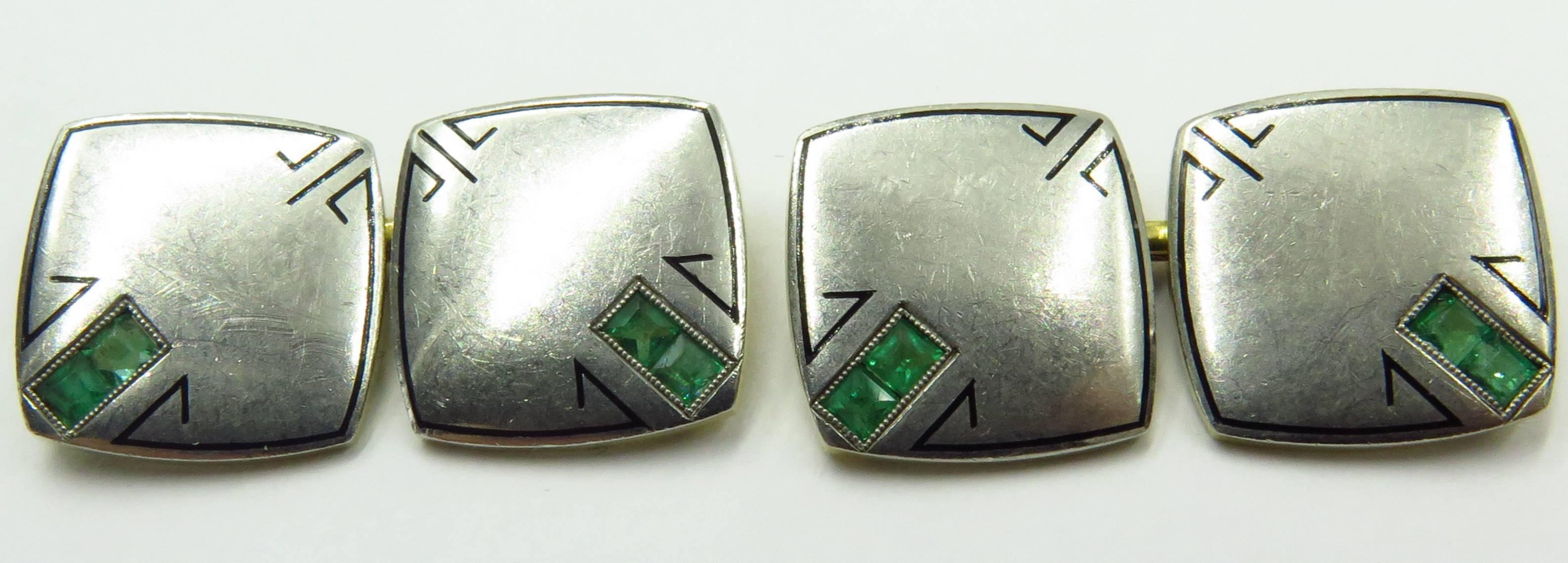 These elegant double sided cufflinks have a very strong arts & crafts period design. Each plaque has 2 square cut emeralds They also contain a platinum and gold mark. There are the initials A.T.S. on the inside of the cufflinks, presumably the