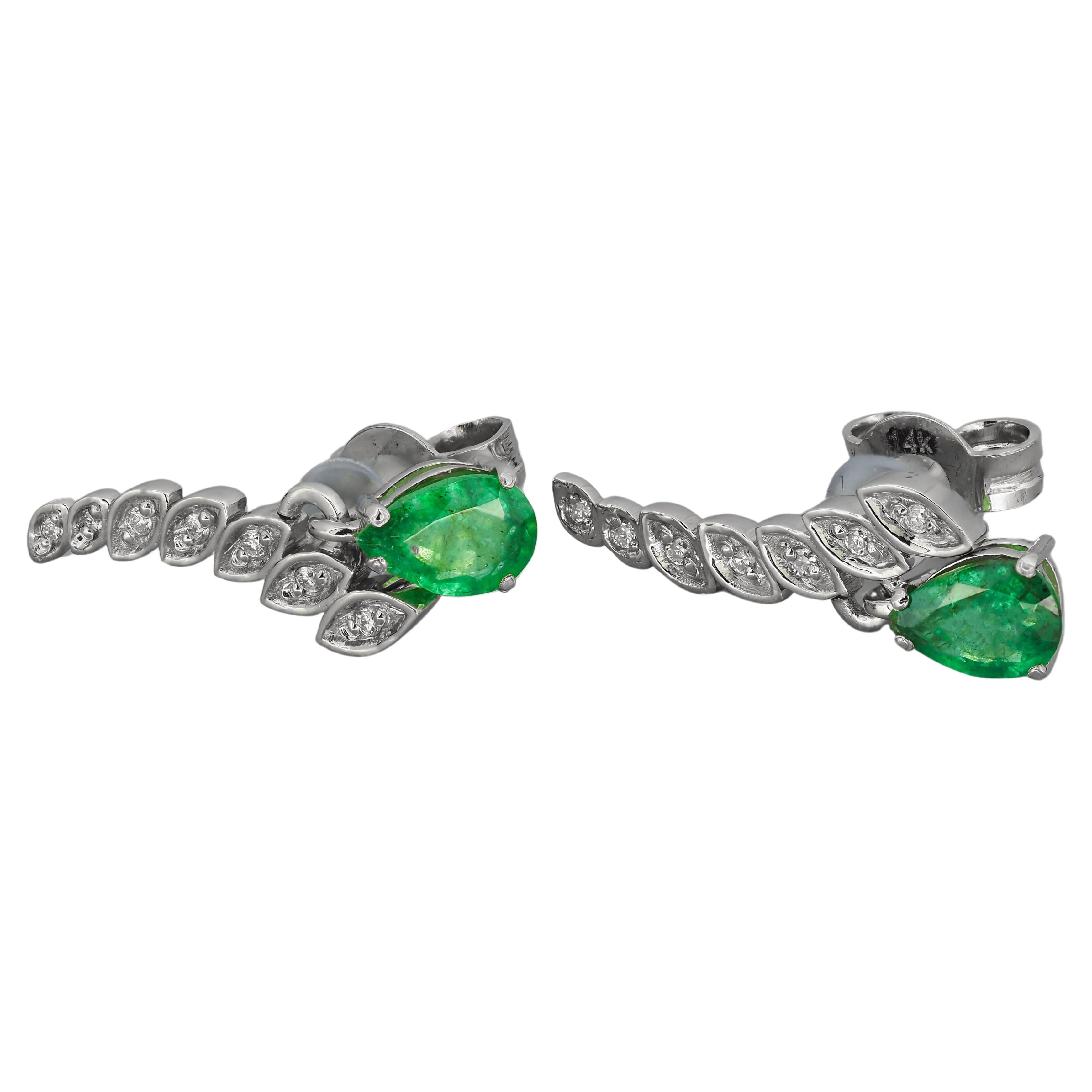 14k gold earrings with pear natural emeralds and diamonds. May birthstone.
Total weight: 2.3 g.
Size: 15.5 x 11 mm.

Central stones: Natural emeralds - 2 pieces
Weight: approx 1.20 -1.25 ct total
Color: green (can be little darker or lighter - you