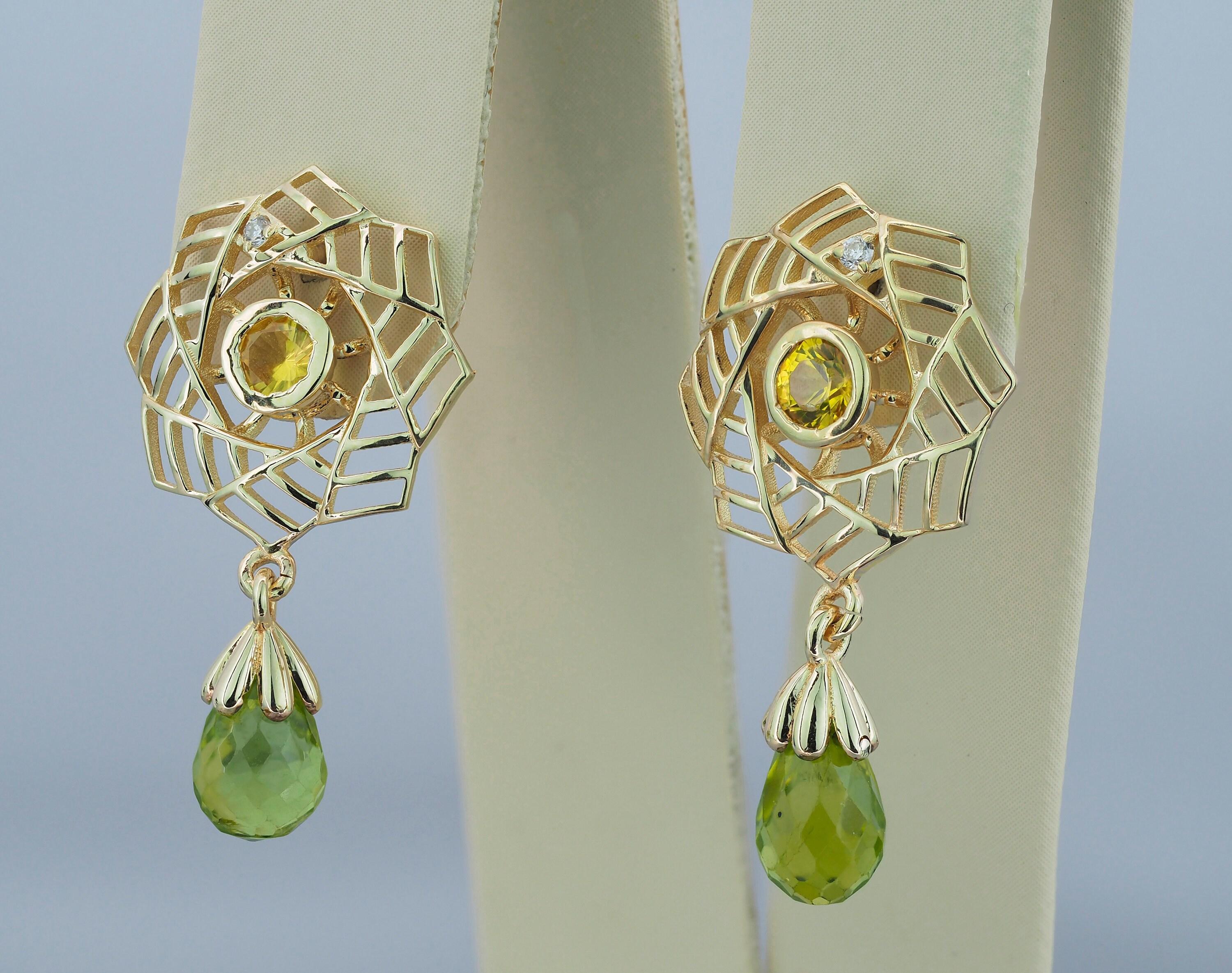 Boucles d'oreilles avec péridots, saphirs et diamants.

Matière : Argent 925
Poids : 2.80 g.
Taille des boucles d'oreilles : 25 x 14 mm

Péridots :
2 pièces, vert - couleur, taille briolette, transparent, (7.5 x 5 mm chaque), approx 2.5 ct
