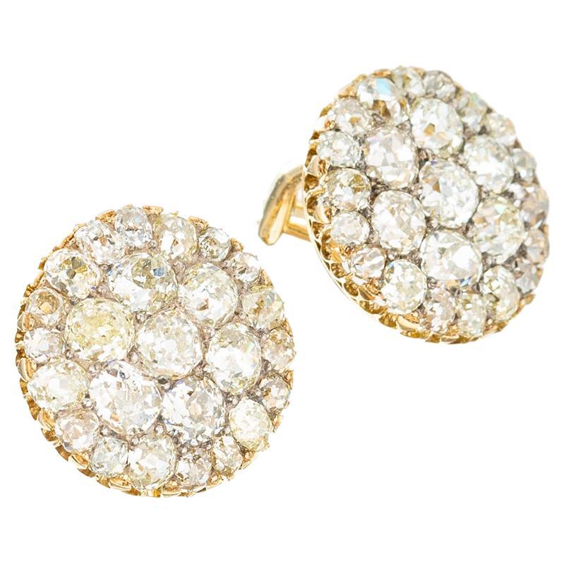 Antique diamond circular-shaped dome earrings, each pavé-set with natural-colored old mine-cut diamonds. Handcrafted in 18k gold.  Fifty diamonds weighing approximately 7.50 total carats (0.30-0.50 carats each). French clip backs marked '14k'.