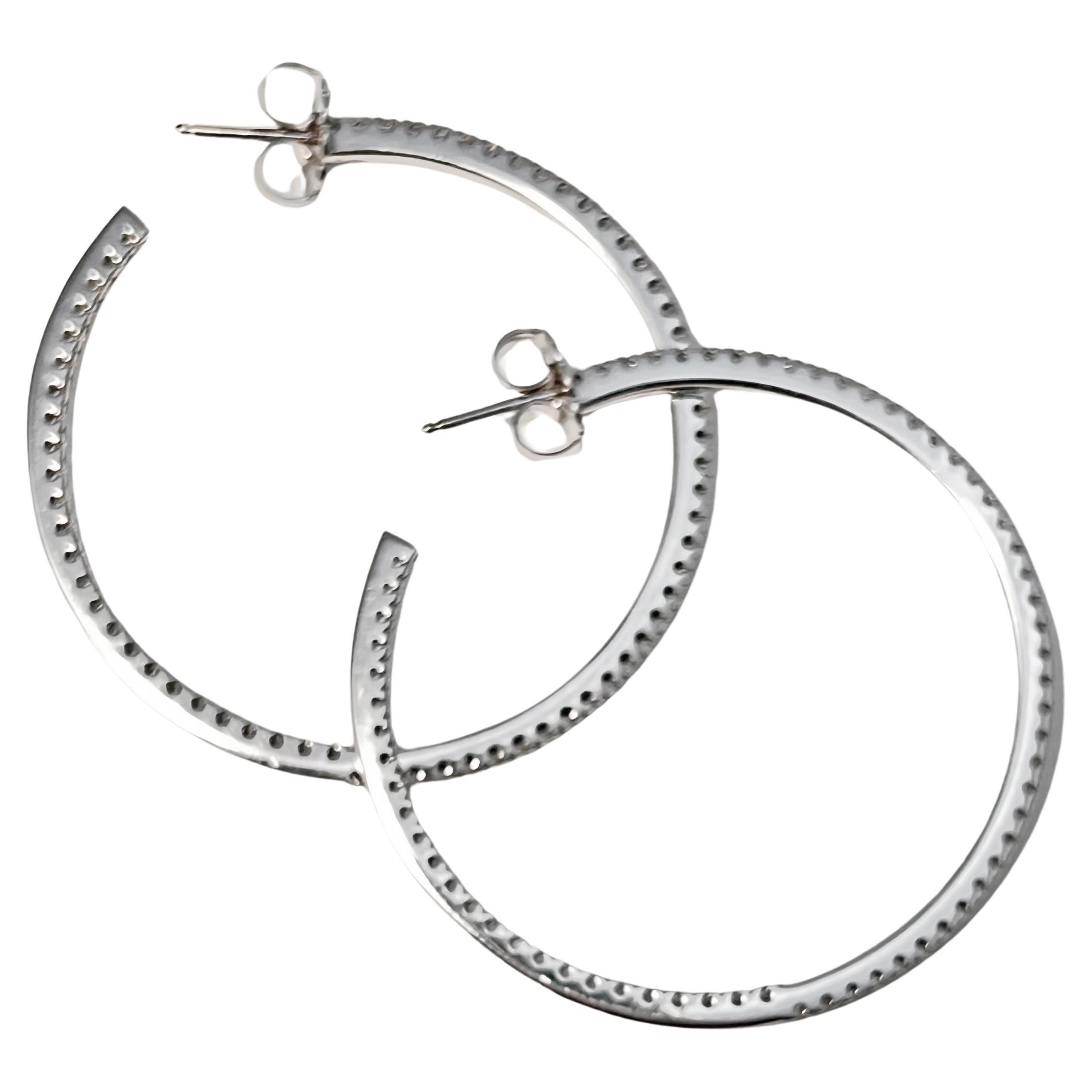 Gucci 18k white gold 'inside out' diamond hoop earrings, featuring one hundred thirty-two round brilliant cut diamonds weighing approximately 1.32 carats (F-G color, VS1-VS2 clarity).  50mm diameter (2