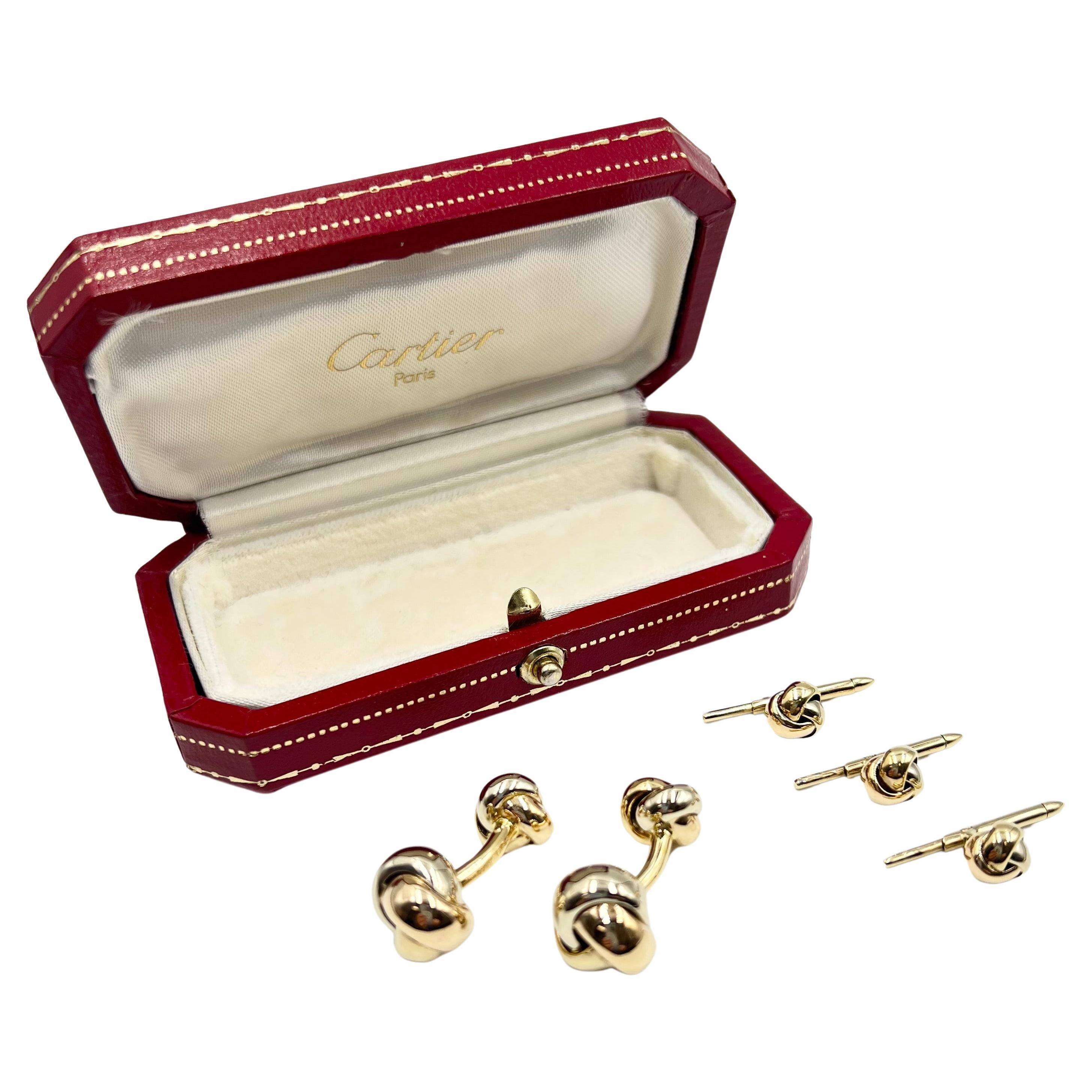 Cartier vintage 18k tricolored gold knot cufflink and shirt stud dress set. The cufflinks feature curved yellow gold bar centers with polished knots in rose, white, and yellow gold. The three matching shirt studs showcase matching miniature rose,