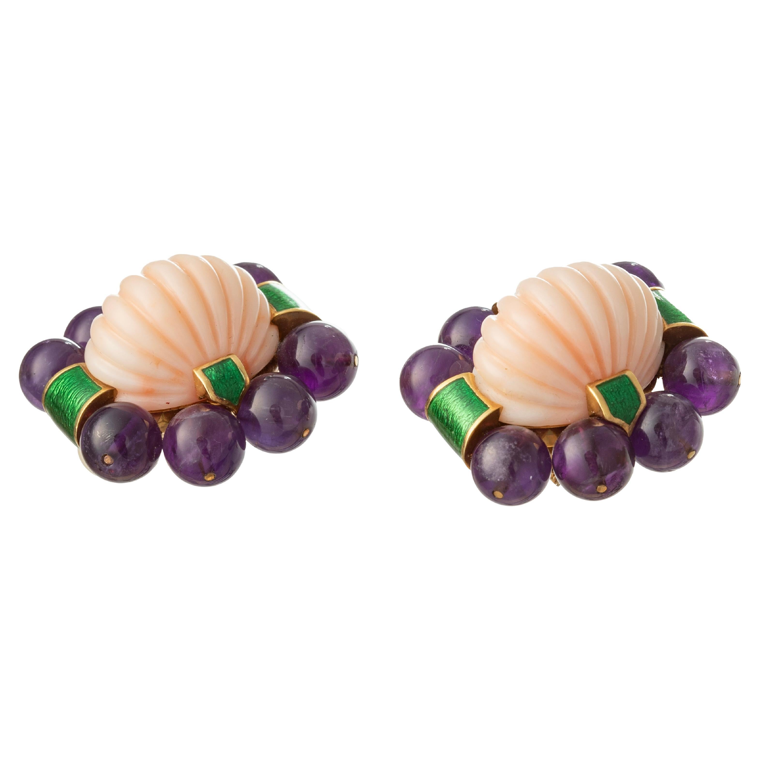 David Webb clip earrings in 18k yellow gold, each centering fluted oval cabochon angel skin pink coral surrounded by eight round amethyst beads and accented by bands of green enamel.  Clip-style backs signed 'WEBB'.  Earring dimensions: 1.3