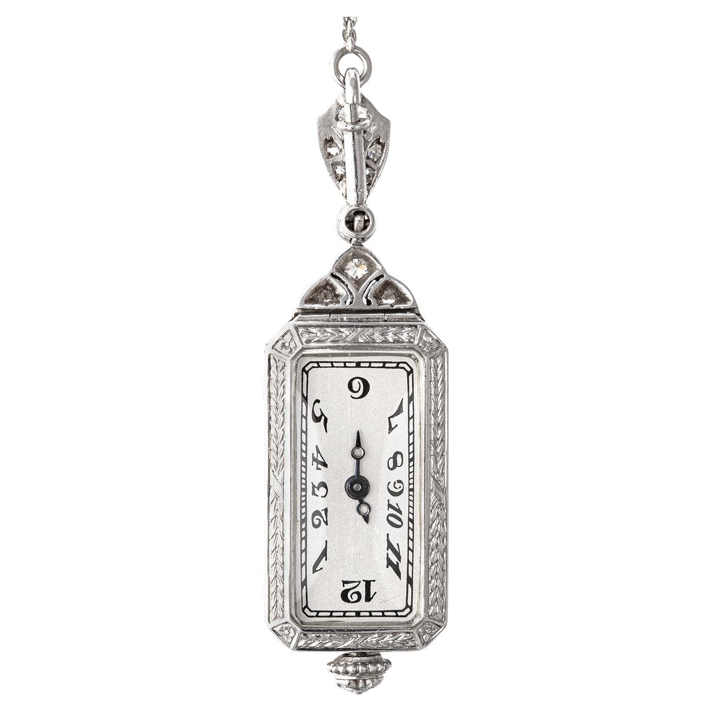 Deco pendant watch on a long sautoir-style chain necklace, the rectangular platinum watch case is finely crafted with pierced cut-out detailing and set with European and rose-cut diamonds over a black enamel background. The reverse side displays an