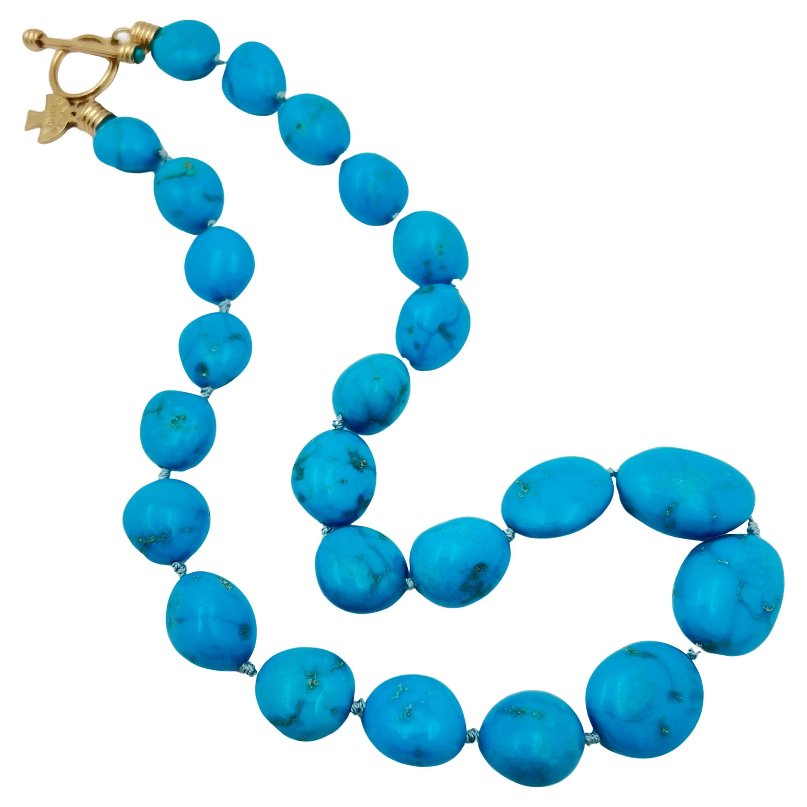 Turquoise bead necklace hand-crafted by the Santa Fe, New Mexico artisan group 'Peyote Bird'.  Twenty-four turquoise beads- graduated in size from 17.67 to 13.5mm each, and knotted in between.  Vibrant blue with natural matrix veining.  14k yellow