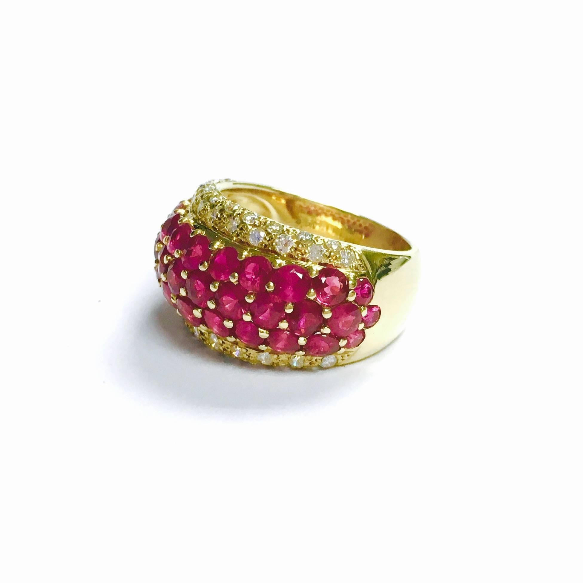 18K yellow gold, approximately 0.5 inch (13mm) wide, slightly domed ring featuring three rows of vivid round cut rubies framed bu diamonds, supported by a 0.25" (6.5mm) wide band.
Ruby: 4.57ctw (stamped inside)
Diamond: 0.63ctw (stamped inside)