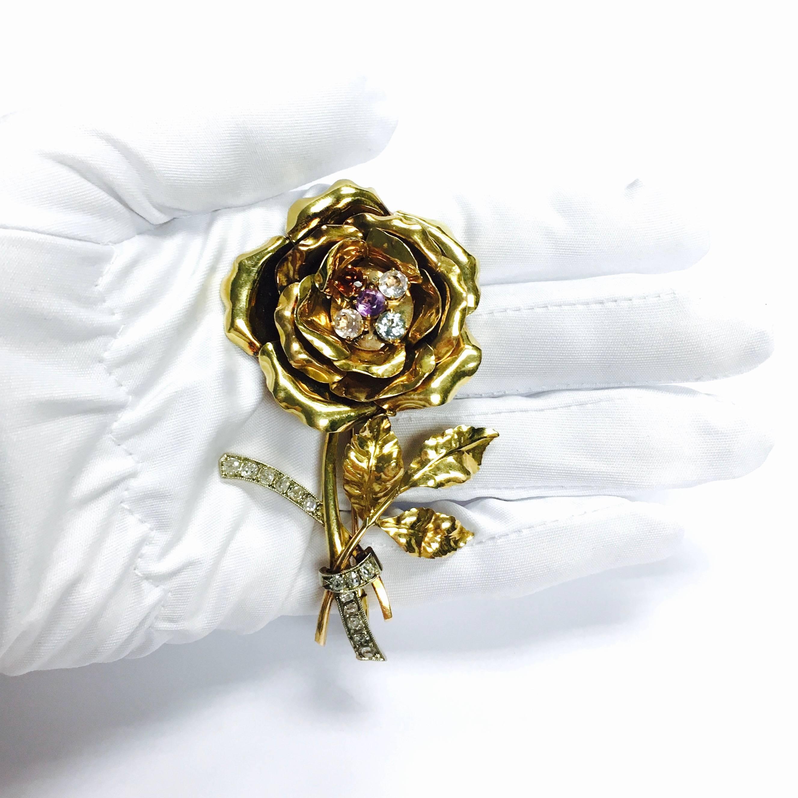 Crafted in 18K yellow gold, set with five round cut colored stones in the center (including amethyst, citrine, aquamarine white zircon and white sapphire), wrapped around with old mine cut diamond set ribbon. Approximate total diamond weight: 1.00ct