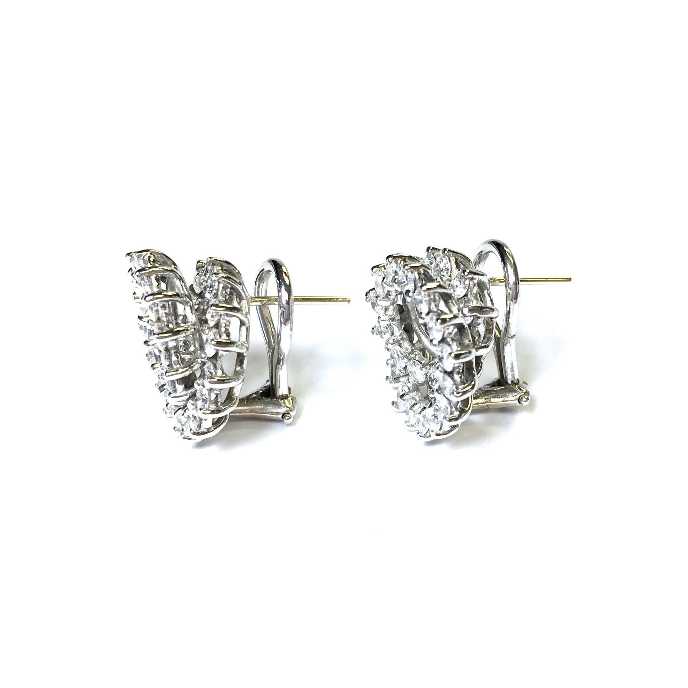 Elegand 14K white gold diamond swirl earrings set with approximately 2.25ct total weight of round brilliant cut diamonds, Color: F-G, Clarity: VS1-VS2
Each earring measures approx. 16 mm ( 5/16" ) in diameter. Post and omega backs. 
Weight: 7.6