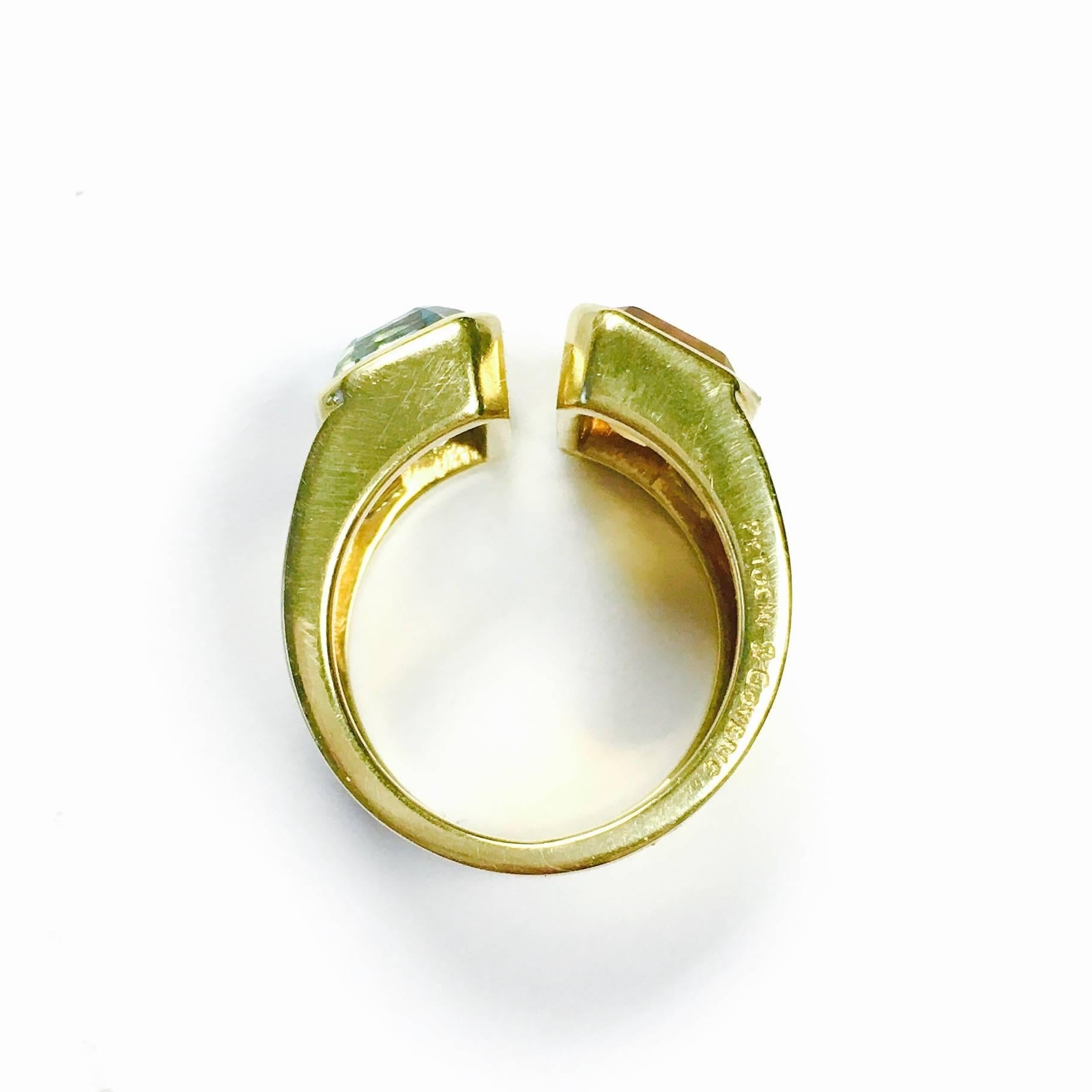 Classic, clean lines and simple elegance. Crafted in 18K yellow gold, the 10 mm wide wrap band features an approximately 5ct bezel set blue topaz on on side of the opening and a 5ct bezel setr citrine on the other. 
Weight: 11.8 grams
Marked: