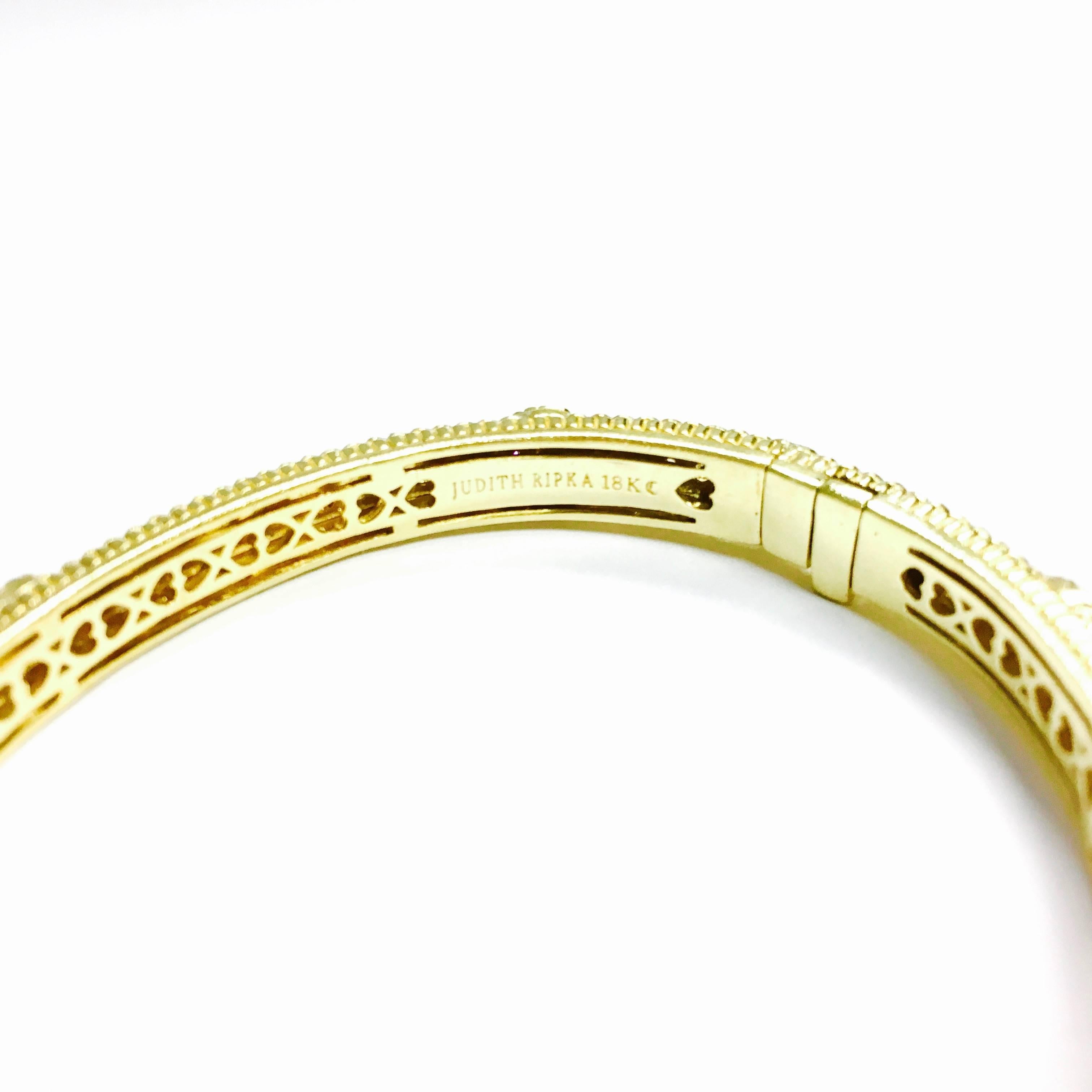 This gorgeous Judith Ripka Couture Collection 'Romance' hinged bangle bracelet offers sparkling 2.00 carats of diamonds set in 18K yellow gold.
Weight: 29 grams 
Measurements:
Inside circumference: 6.5 inches
Bracelet Diameter: 2.25 inches