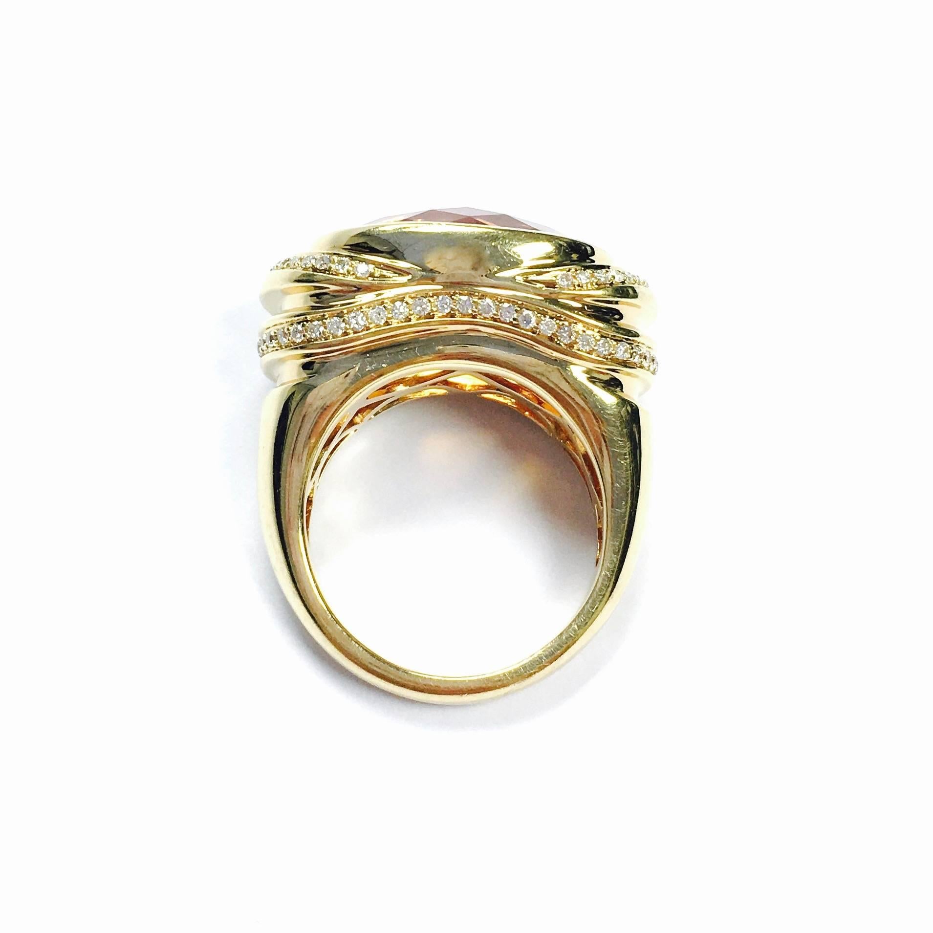 Crafted in 18K yellow gold, featuring an approximately 15 carat  bezel set oval checkerboard cut citrine, supported by scalloped diamond set shoulders and a fully finished under gallery, completed by a three millimeter wide band. 
The front