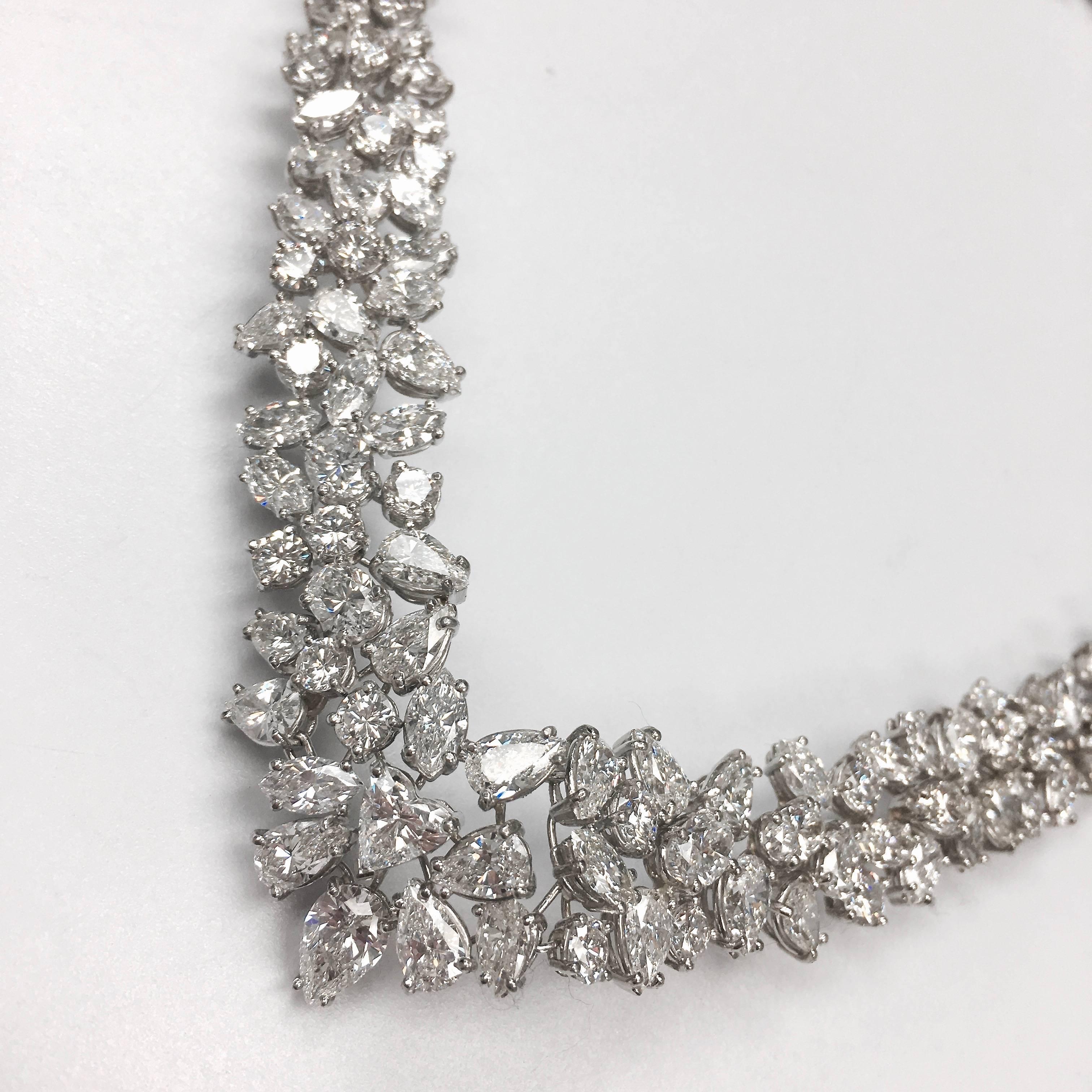 A diamond necklace of flexible tapering design, composed of a graduated series of round brilliant, marquise and pear shape diamond foliate clusters with one heart shape diamond solitaire on the front. Mounted in platinum. 
221 diamonds, approximate