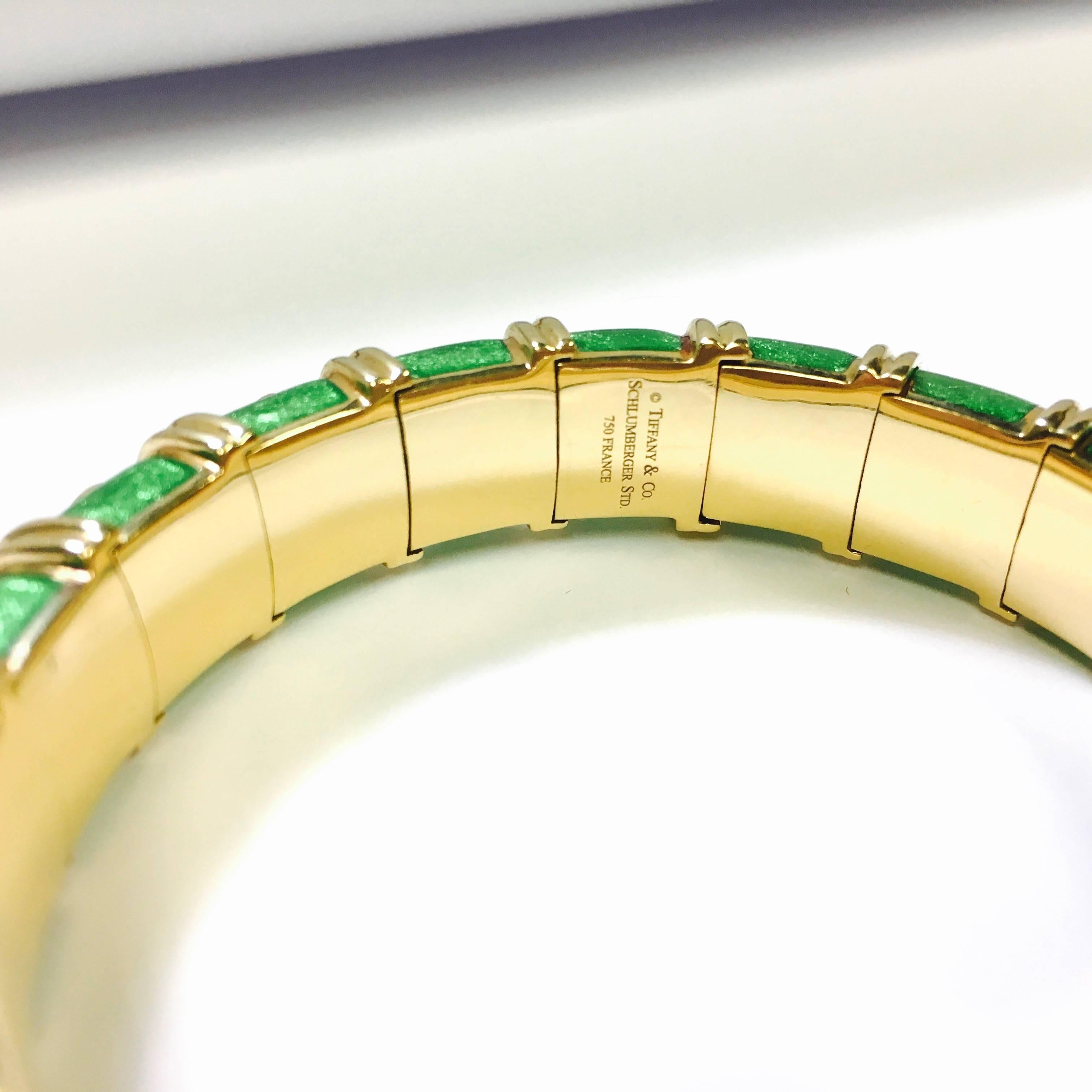 Jean Schlumberger designed Croisillon bangle bracelet for Tiffany & Co. Crafted in 18k yellow gold with bright apple green enamel. The piece is hallmarked: “TIFFANY&Co. SCHLUMBERGER STD 750 FRANCE on the inside of the bracelet. 
Measurements: