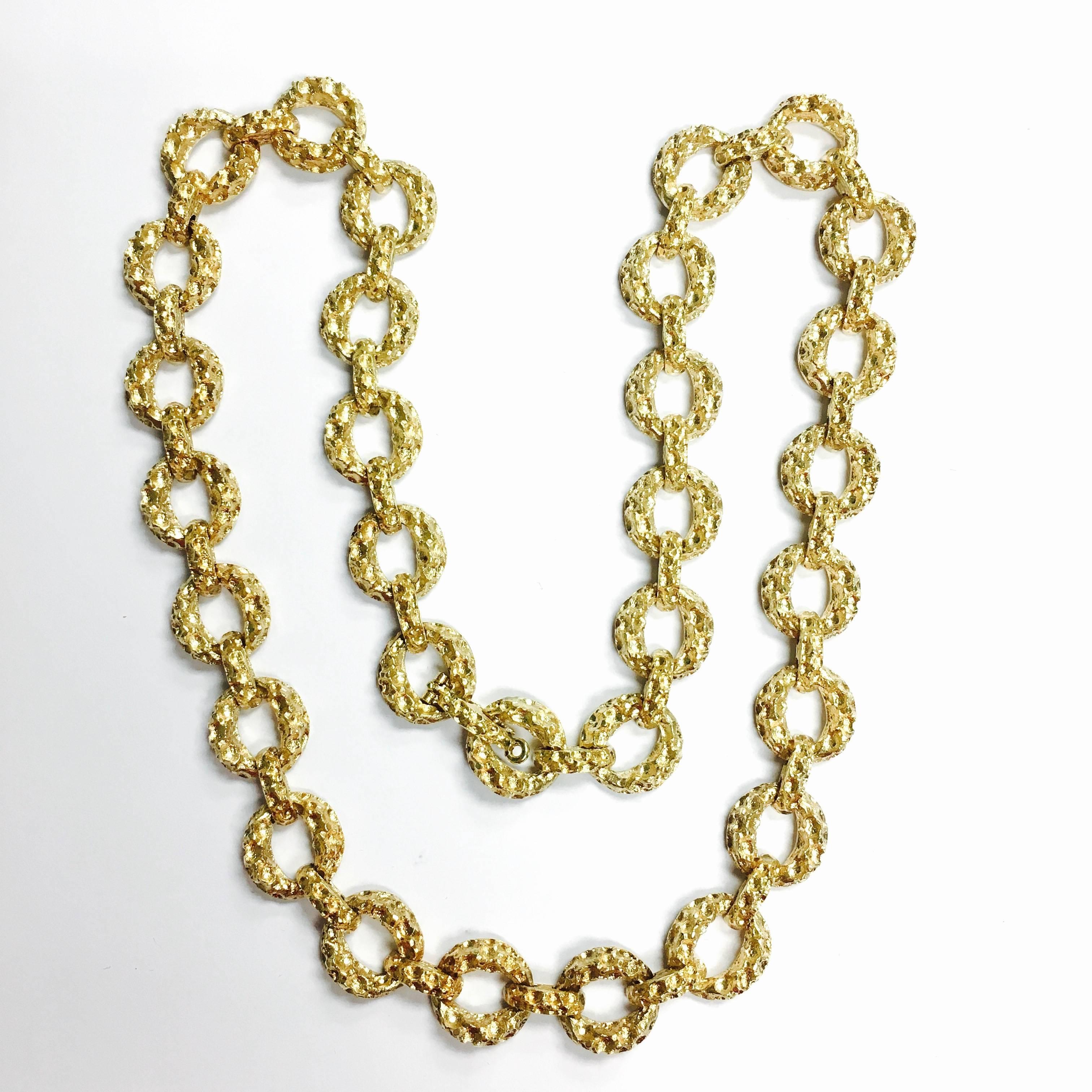 Crafted in 14K yellow gold with a textured finish, the necklace features a diamond set large pendant enhancer, supported by a heavy round textured links chain. 29 round brilliant cut diamonds,approximate total weight: 1.7ct., Color: F-G, Clarity: