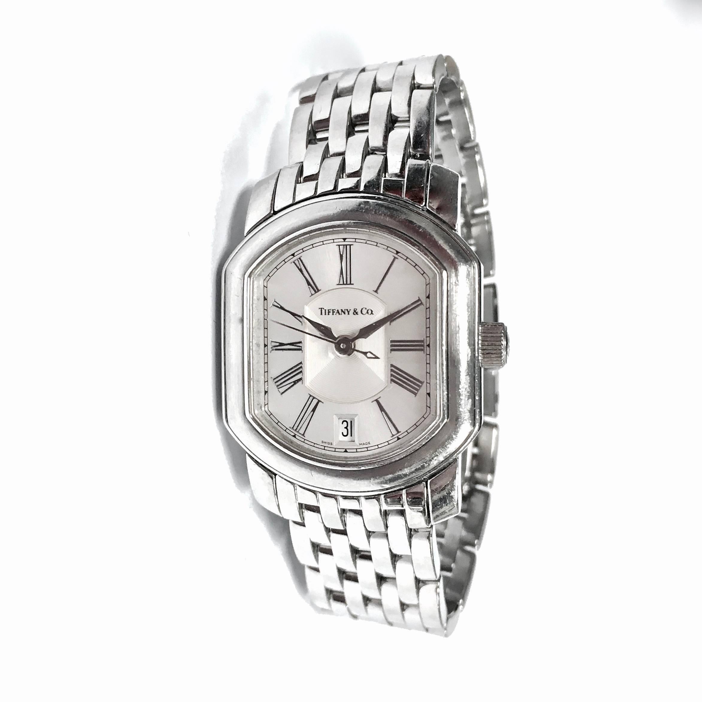 Tiffany and Co. Mark Coupe Resonator stainless steel automatic wristwatch.
Case Measurement: 24 mm x 28 mm
Dial:	Silvered Dial with Silver Roman Numerals
Material:	Stainless Steel
Clasp: Double Locking Foldover Clasp
Crystal: Scratch Resistant