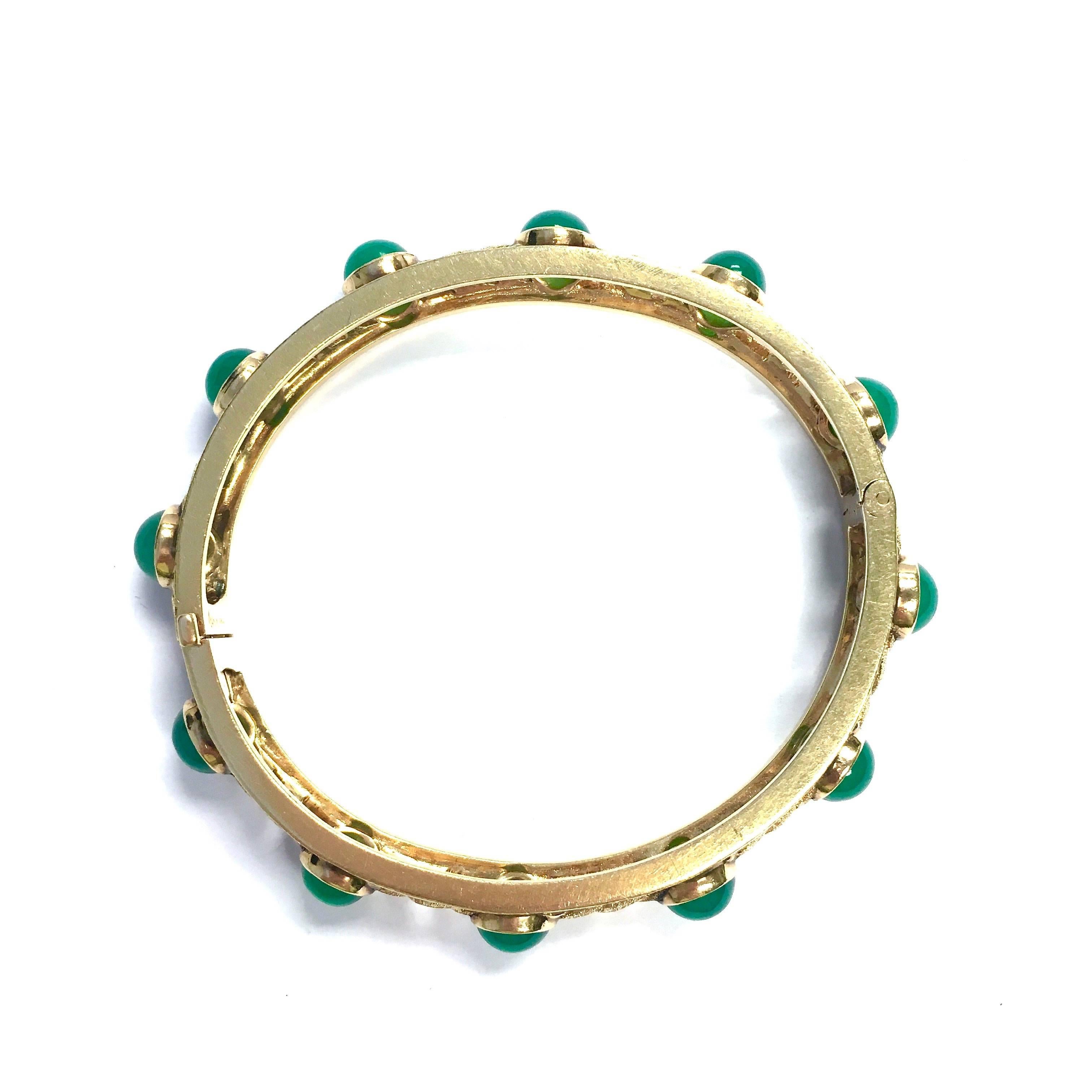 An other master piece of William Ruser. The bracelet is crafted in 14K yellow gold, featureing twelve bezel set round cabochon green chalcedony incorporated with a textured finished wavy design. 
Measurements: 
Inner circumference: 6.75