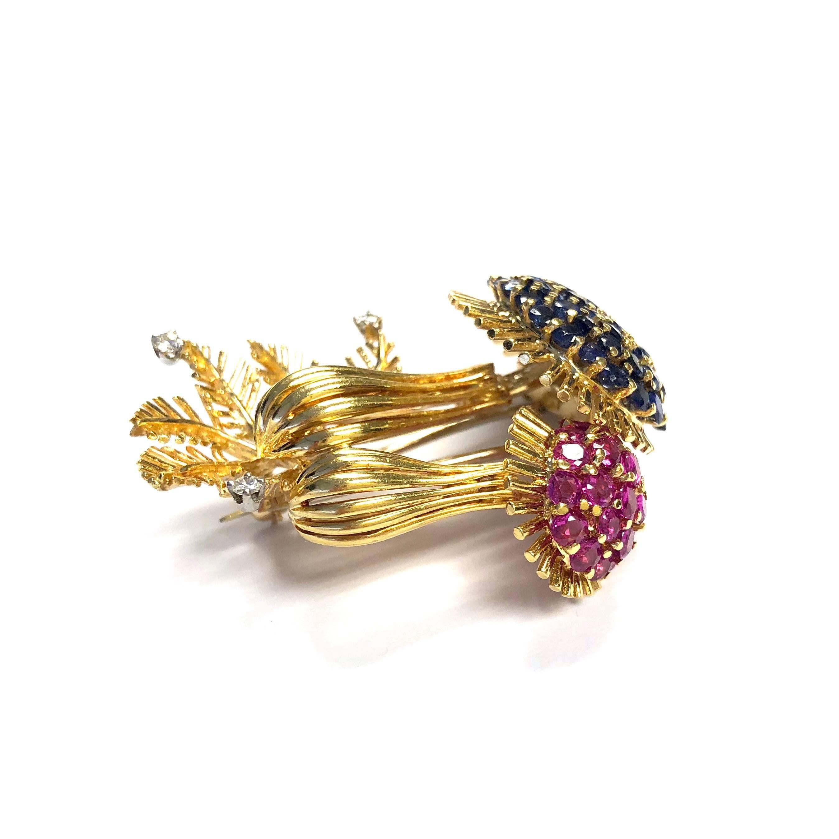 Crafted in 18K yellow gold, set with rubies, sapphires and diamonds. 
Measurements: 1 11/16