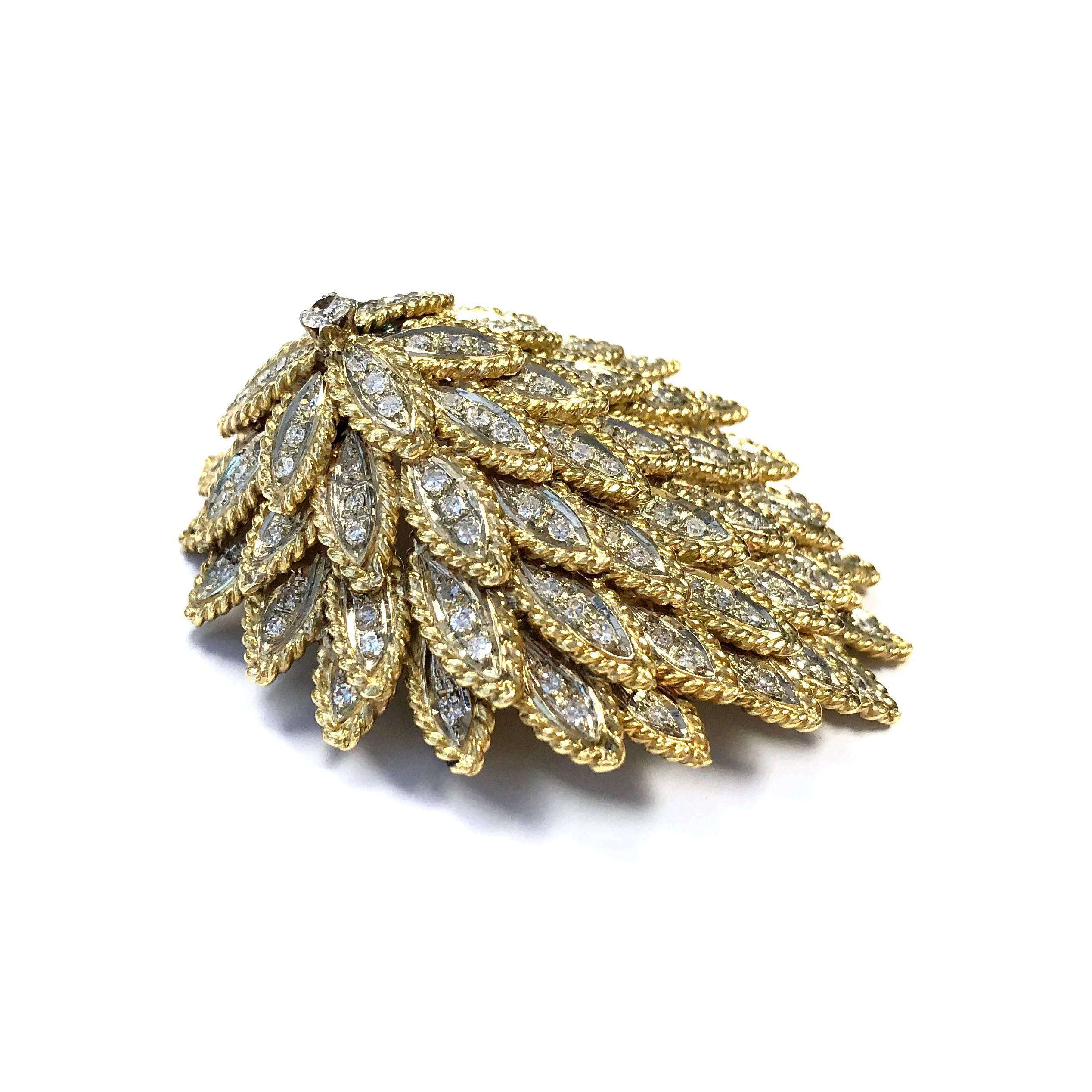 Amazing workmanship paired with high quality materials. Crafted in 18K gold, composed of a multi-tiered three dimentional design of diamond set feathers.
Each feather features a three single cut diamond set, marquise shape white gold section