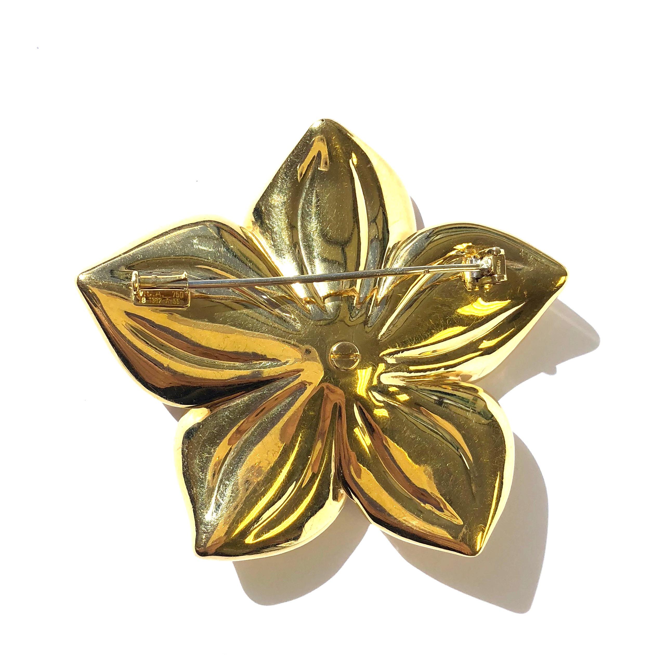 Gorgeous vintage large Van Cleef & Arpels flower brooch, featuring a cluster of eight round brilliant cut diamonds in center, surrounded by five flower petals. 
Approximate total diamond weight: 0.90ct. Color: G, Clarity: VS
Measurements: 2 11/16