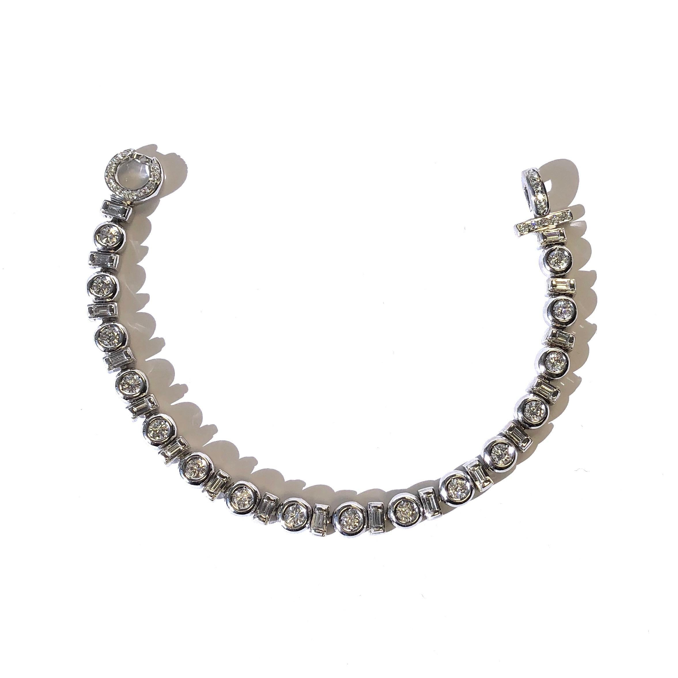 Crafted in 18K white gold, the bracelet is composed of a series of alternating bezel set round and baguette cut diamonds, Seven and one half inch length terminating in a diamond set fold over clasp. 
Approximate total diamond weight: 4.50ct. Color: