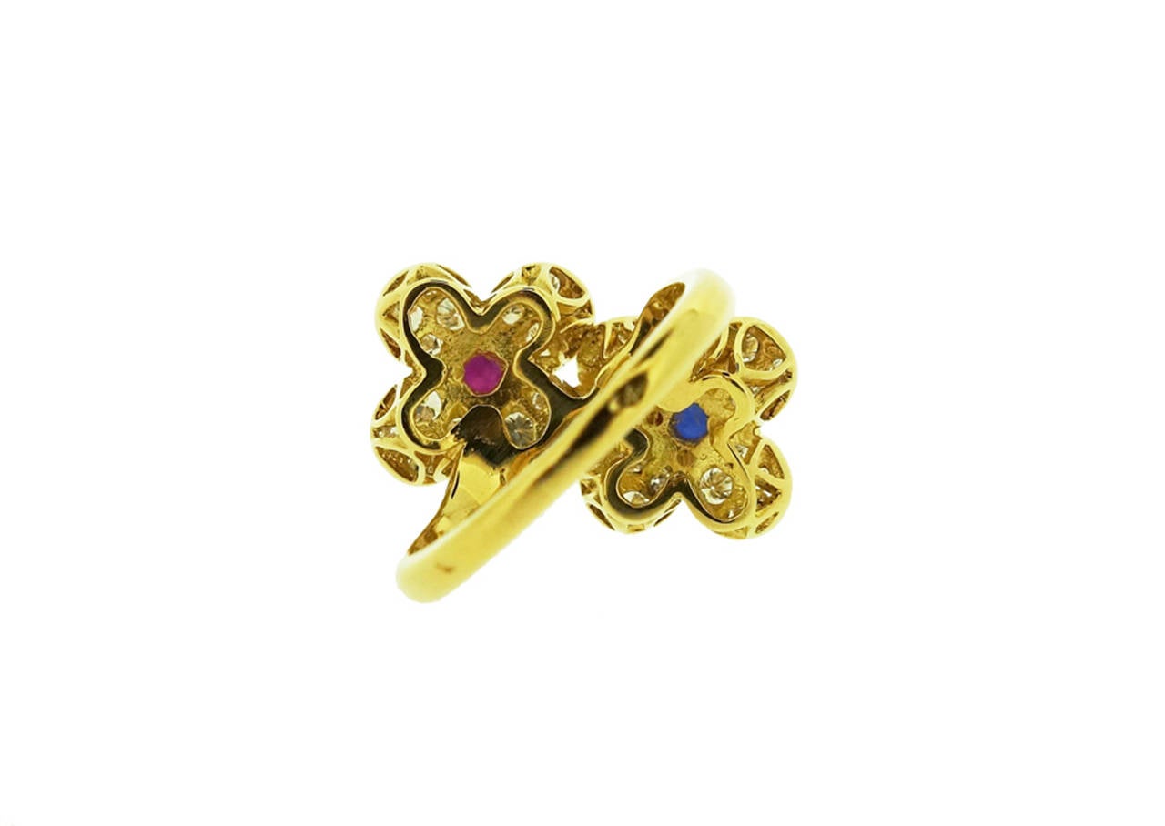 Van Cleef & Arpels 18K yellow gold ring with one Ruby & Diamond set and one Sapphire & Diamond set florets. Total diamond weight: approx. 1.20ct, one cabochon Sapphire and one cabochon Ruby, approx. total weight: 0.70ct

Measurements: