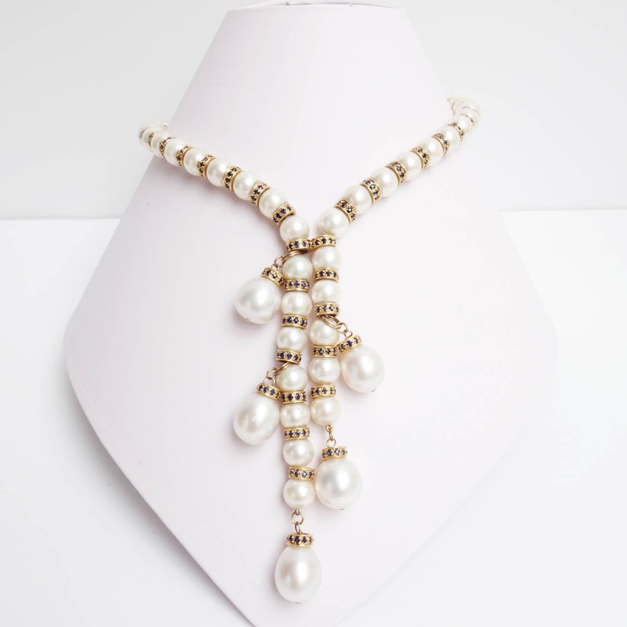 One of a kind white South Sea pearl fringe necklace, composed of fifty 9mm round pearls alternating with 14K yellow gold blue Sapphire set spacers. There are five off-round to baroque shape 12mm to 13mm pearls dangling from the strand. The pearls