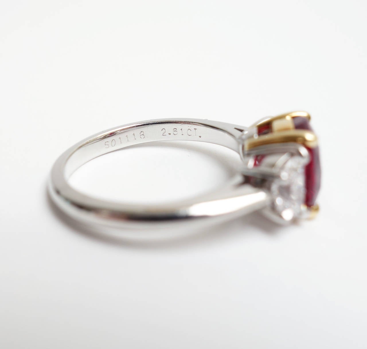 Classic elegance. a 2.61ct Burmese Ruby set in 18K yellow gold, accented by two half moon cut diamonds set in platinum.  The ring originaly sold by Tiffany & Co. as not treated. Tiffany & Co. appraisal included with the original certificate.