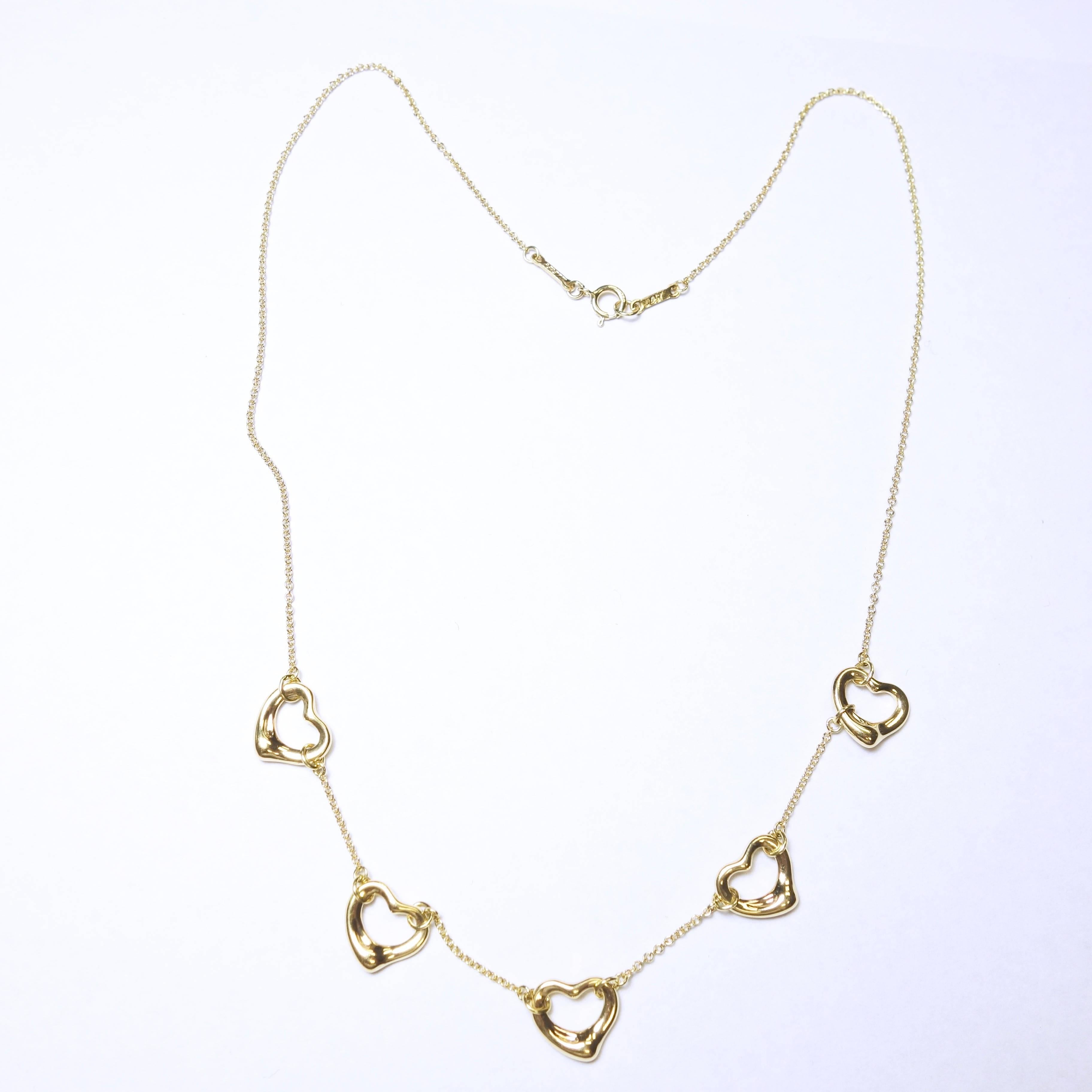 Here's a open heart yellow gold necklace from TIFFANY & Co by ELSA PERETTI Five open hearts necklace in 18K yellow gold. Made in Spain
Length: 16 inches.
5 HEARTS PENDANT, each measures approx. 11mm wide x 9.6mm long
HALLMARKED: TIFFANY & CO,