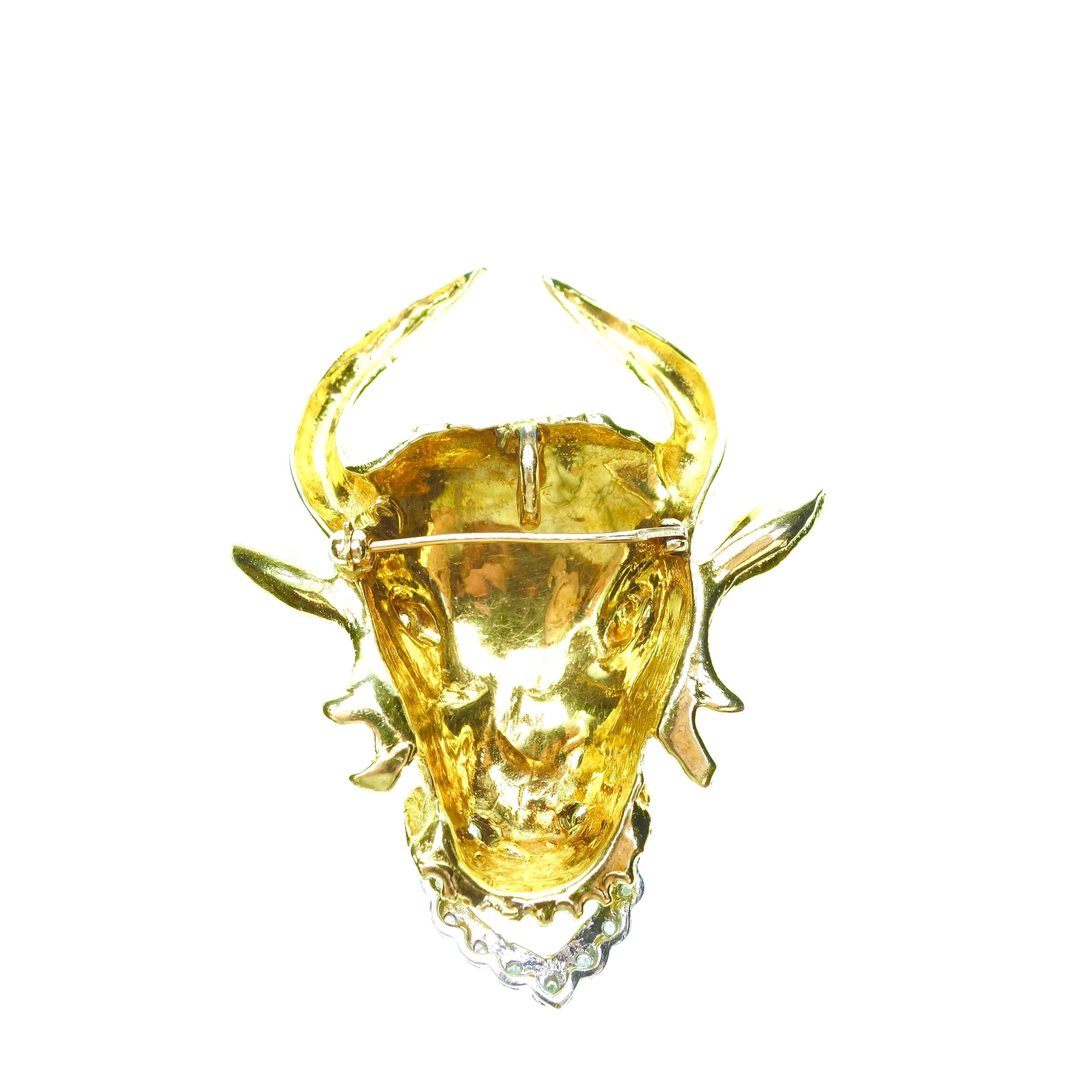 Custom made hand crafted 1960s 14K yellow and white gold large bull's head brooch/pendant with diamonds. 11 round brilliant cut diamonds, approximate total weight of 0.25ct.
Measurements: H 60mm x W 49mm x D 14mm
Weight: 38.2 grams
