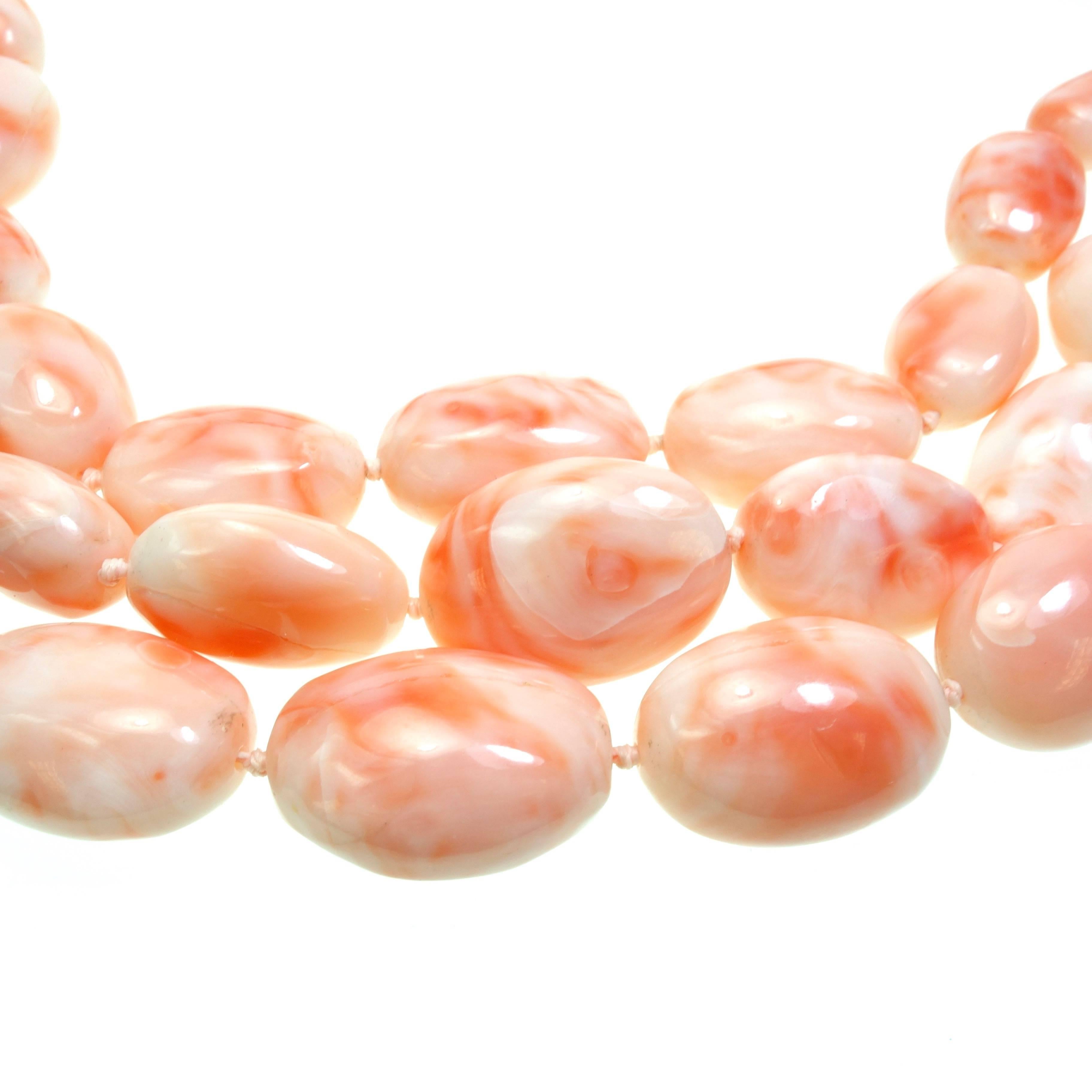 Gorgeous triple strand Angel Coral large beads necklace from Cristina Ferrare's jewelry line. The meads are measuring from 13x10mm up to 24x18mm. Seventeen inch length terminating in a 14K yellow gold clasp with the designer's logo. 
Weight: 262