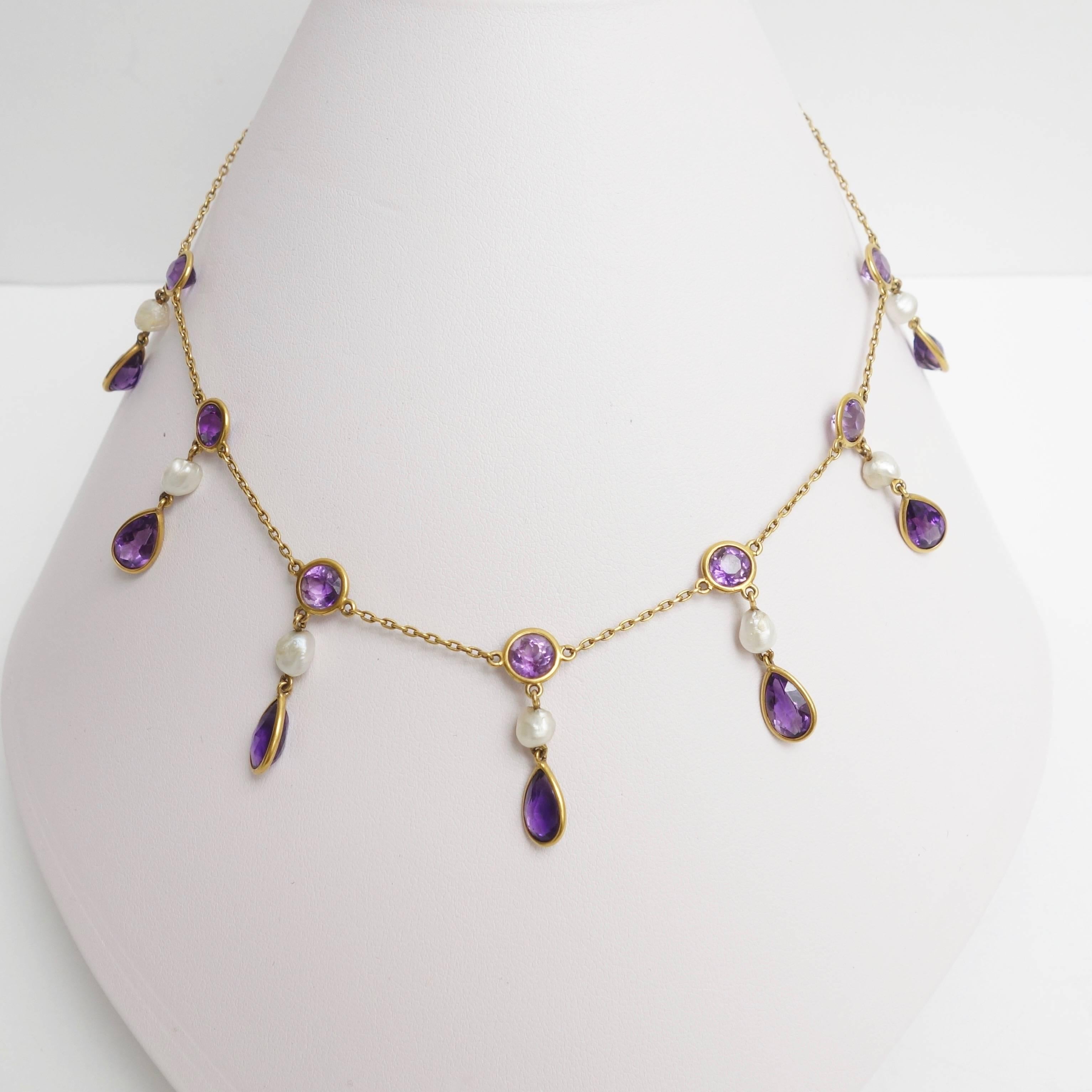 Crafted in 18K yellow gold, the necklace features seven amethyst and natural pearl pendants. Each pendant is composed of a bezel set pear shape amethyst supported by a baroque shape natural pearl and a bezel set round amethyst. 
Approximate total