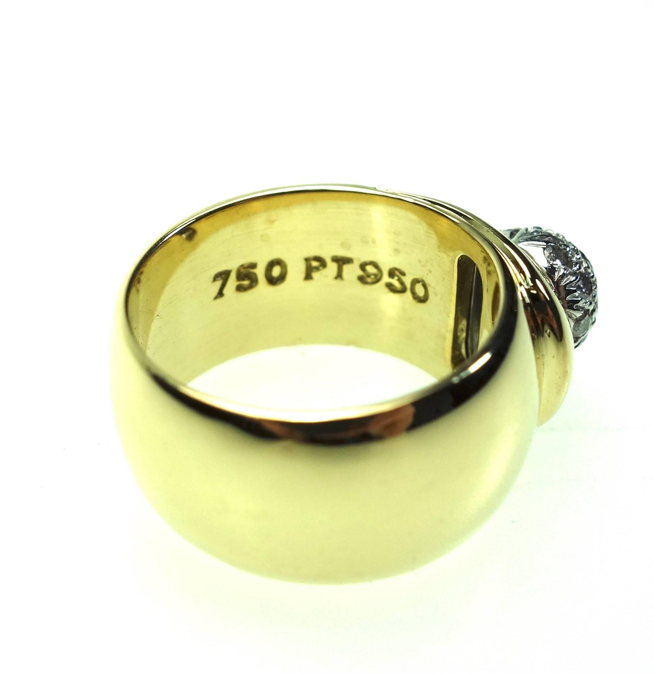 Vintage Tiffany & Co. ring from 1980 is a stunner. The 18k yellow gold 9.5 mm wide band features a platinum pave set diamond ball set with 19 round brilliant cut diamonds, approximate total weight 0.50ct. 
Clarity: VS1-VS2, Color: F-G
Weight: 15.2