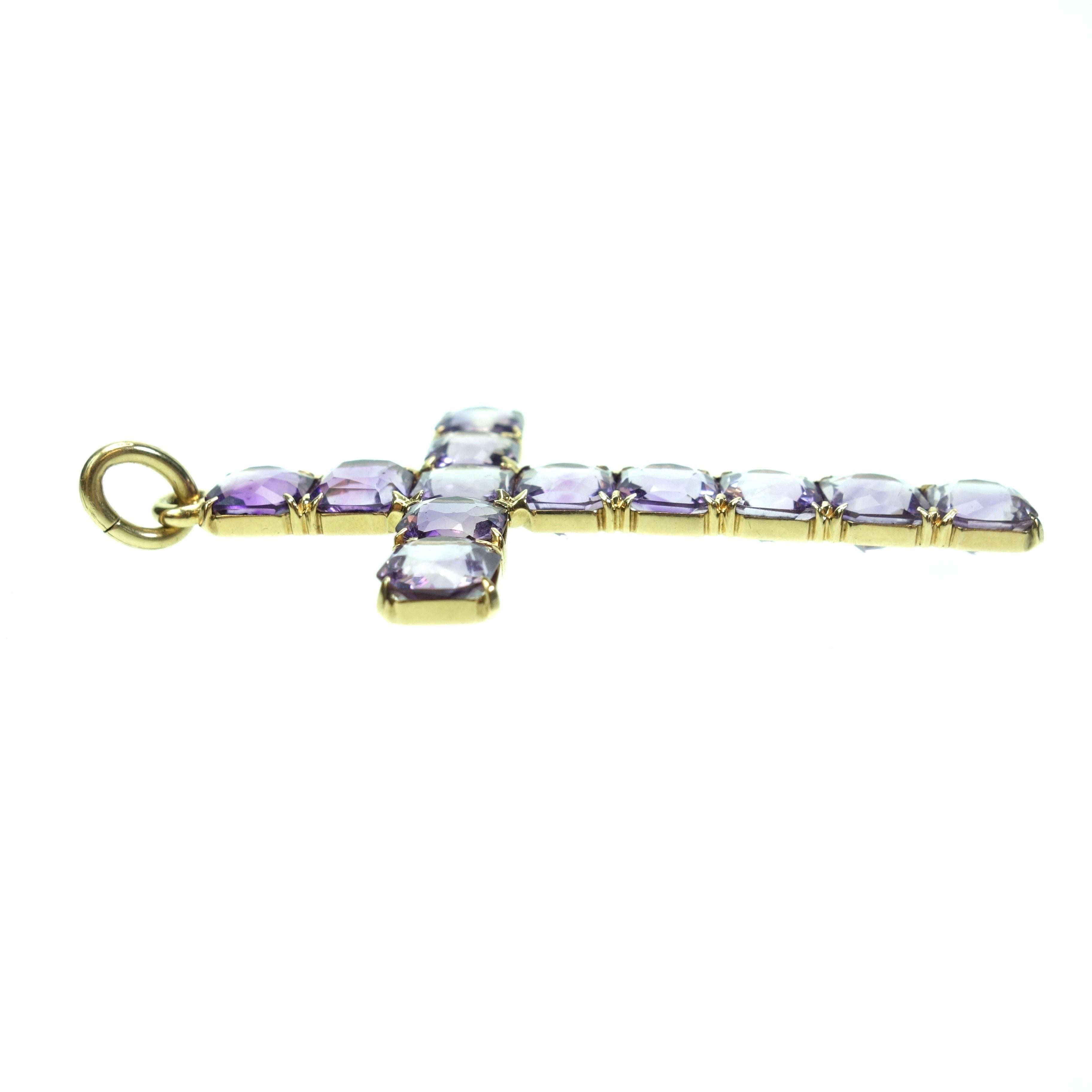 Amazing cross crafted in 14K yellow gold from the late 1890's.  The cross is set with 12 antique cushion cut purple amethyst stones. 

Measurements: 67 mm Hight x 35 mm Width
Weight: 8.8 grams
Marked: 14K and the Sloan & Co. makers mark