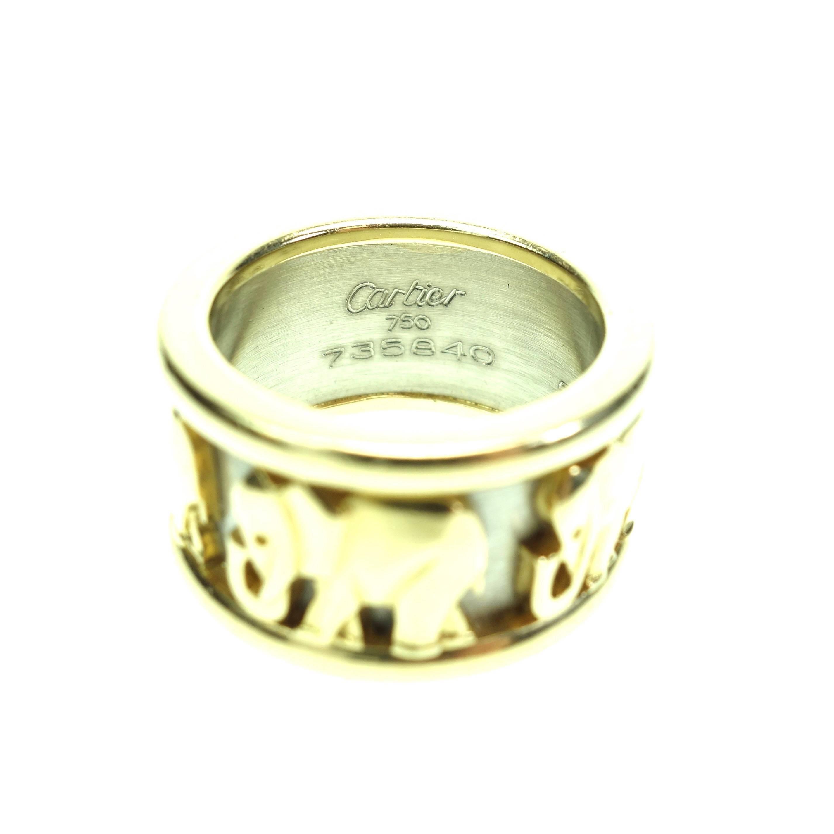 The ring has a high relief carving of elephants going around the entire ring. The relief portions are high polish and the sections that are set back have a white gold satin finish. 

Metal: 18K White & Yellow Gold
Hallmark: Cartier 750 735840