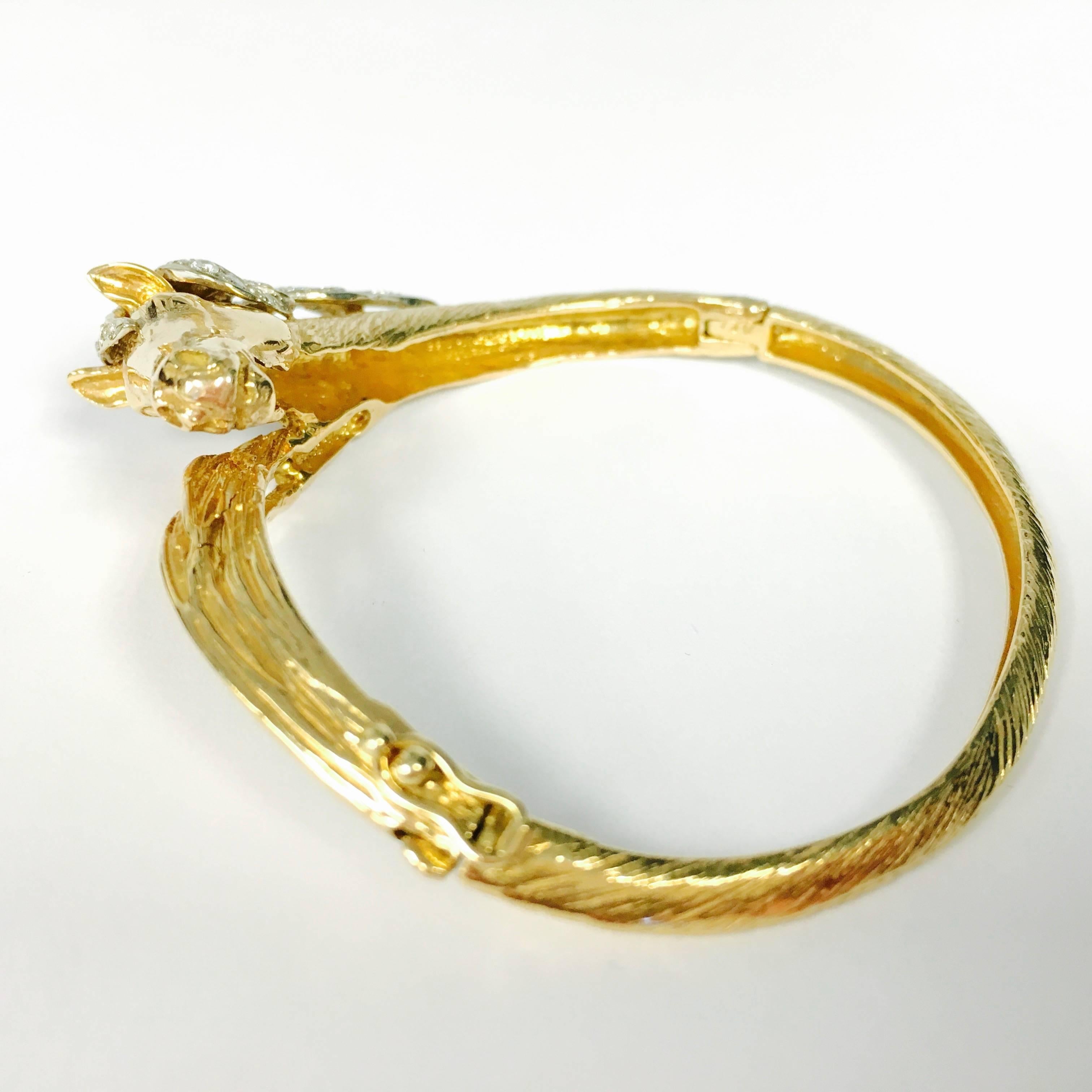 Any horse lover would appreciate this sweet piece from the 1960s. The hinged bangle is crafted in 14K yellow gold with a bark finish, featuring a horse head with white gold diamond set mane. 42 diamonds, approxiamte total weight of 1.00ct. 
Color: