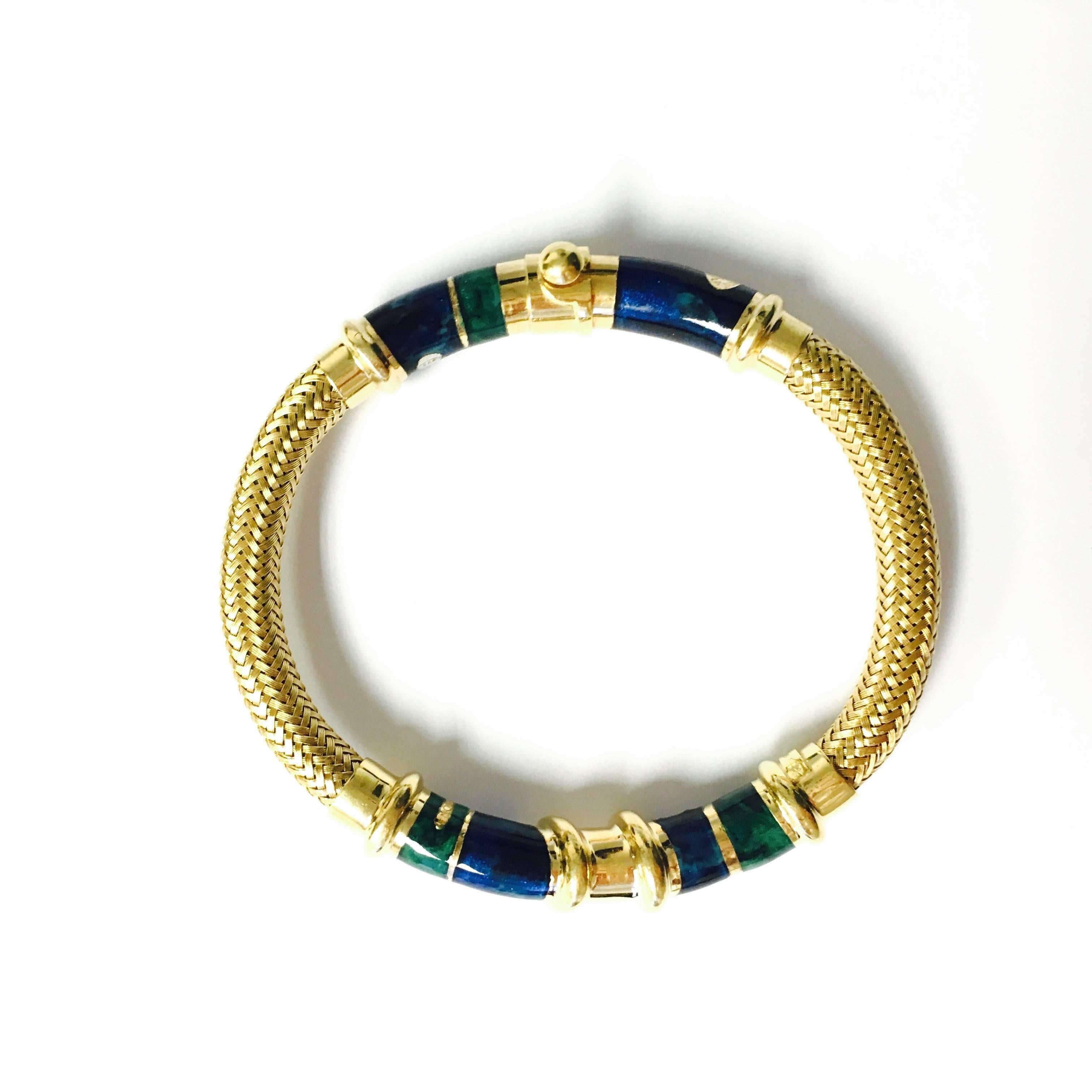 Embellish yourself with exotic flair in this designer La Nouvelle Bague enamel bangle bracelet. Crafted of mesh design yellow gold cable accented with  marbled, green and cobalt color enamel, abstract design elements. 
DESIGNER / HALLMARKS: La