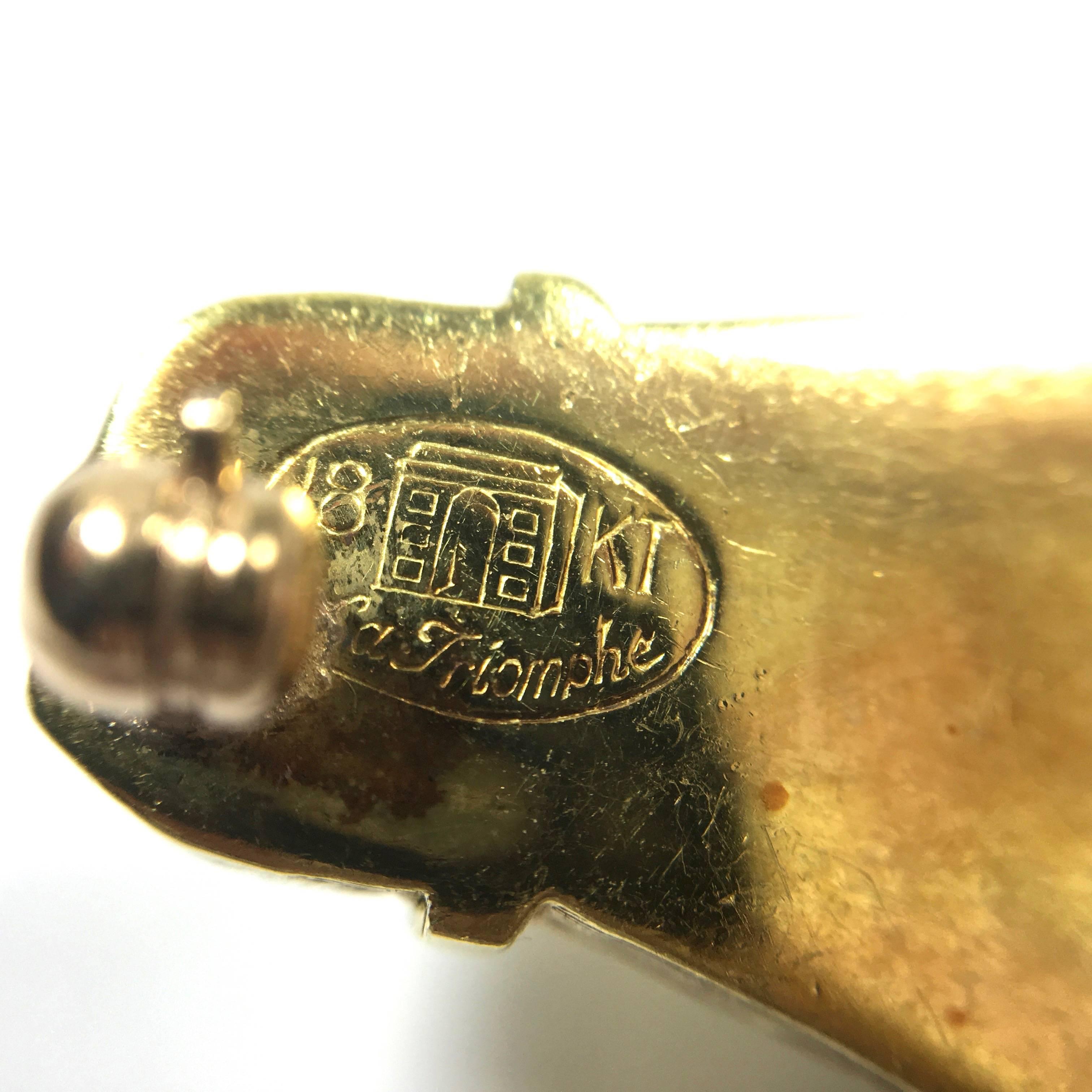 Fantastic figural horse head pin for collectors. Made and signed by LA TRIOMPHE. Heavy gauge 18K brushed yellow gold. Set with cabochon lapis eye and diamond collars. 
Measurements:
Width: 31.5 mm
Height: 20 mm
Weight: 11.4