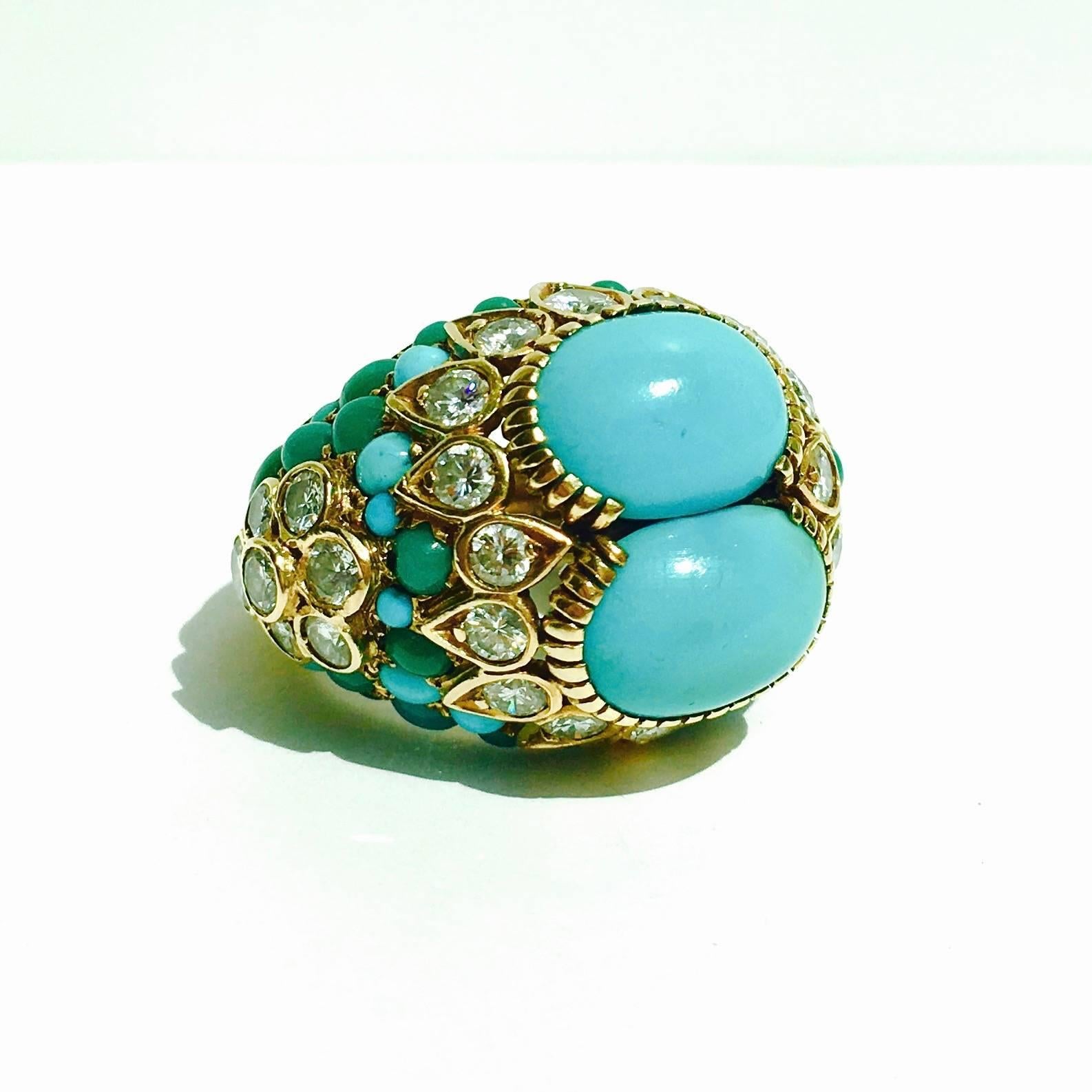 Important Cartier 18K yellow gold turquoise and diamond bubble ring from the 1960's. Featuring two 12 x 9 mm oval cabochon turquoise on the front surrounded by 30 round brilliant cut diamonds approximate total weight of 3.00ct, and round cut green