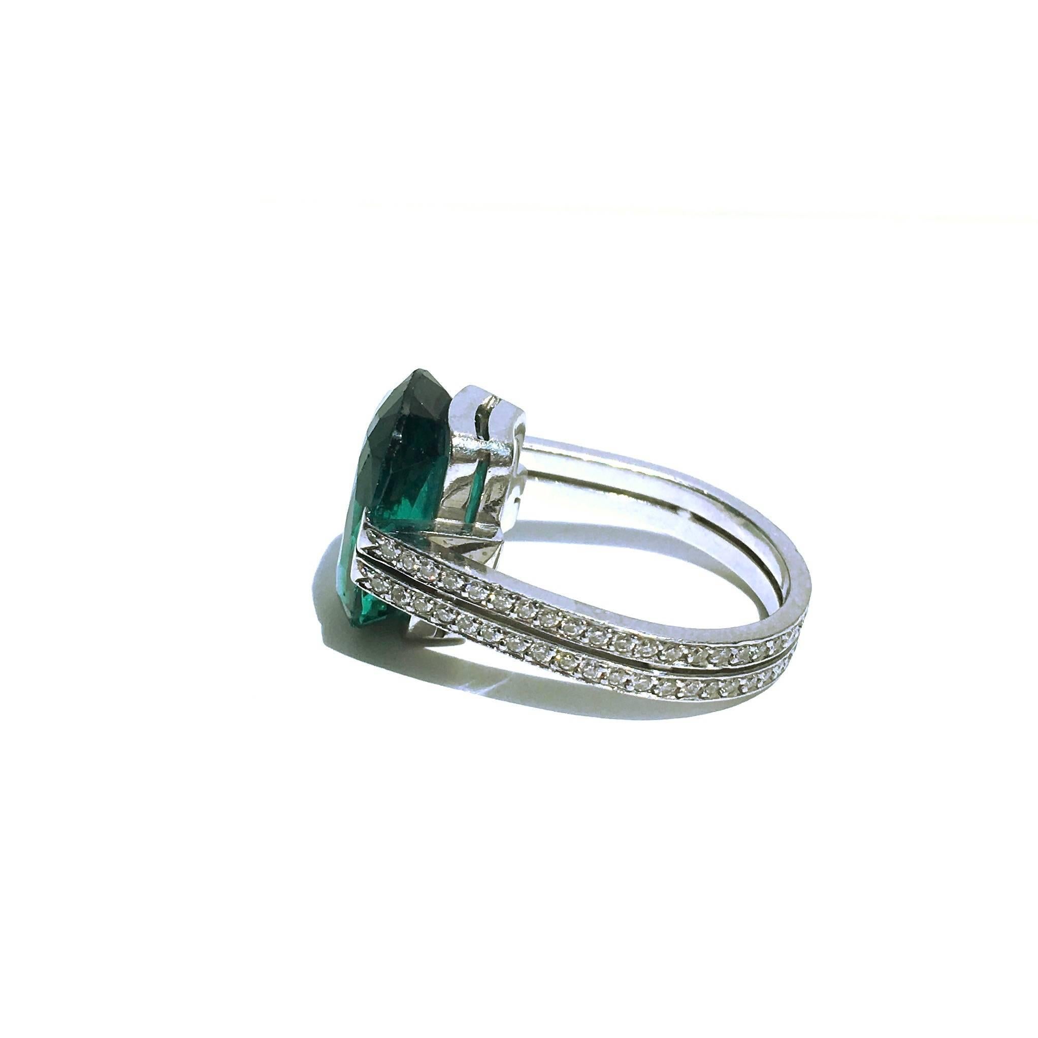 Tanagro platinum ring, featuring a mesmerizing 15 x 11 mm blue-green tourmaline (approx. 10ct), supprted by a 4 mm wide diamond set double platinum band. 86 diamonds, approx. total weight of 1.00ct.
Size: 7.5
Weight: 11.1 grams

Pietro