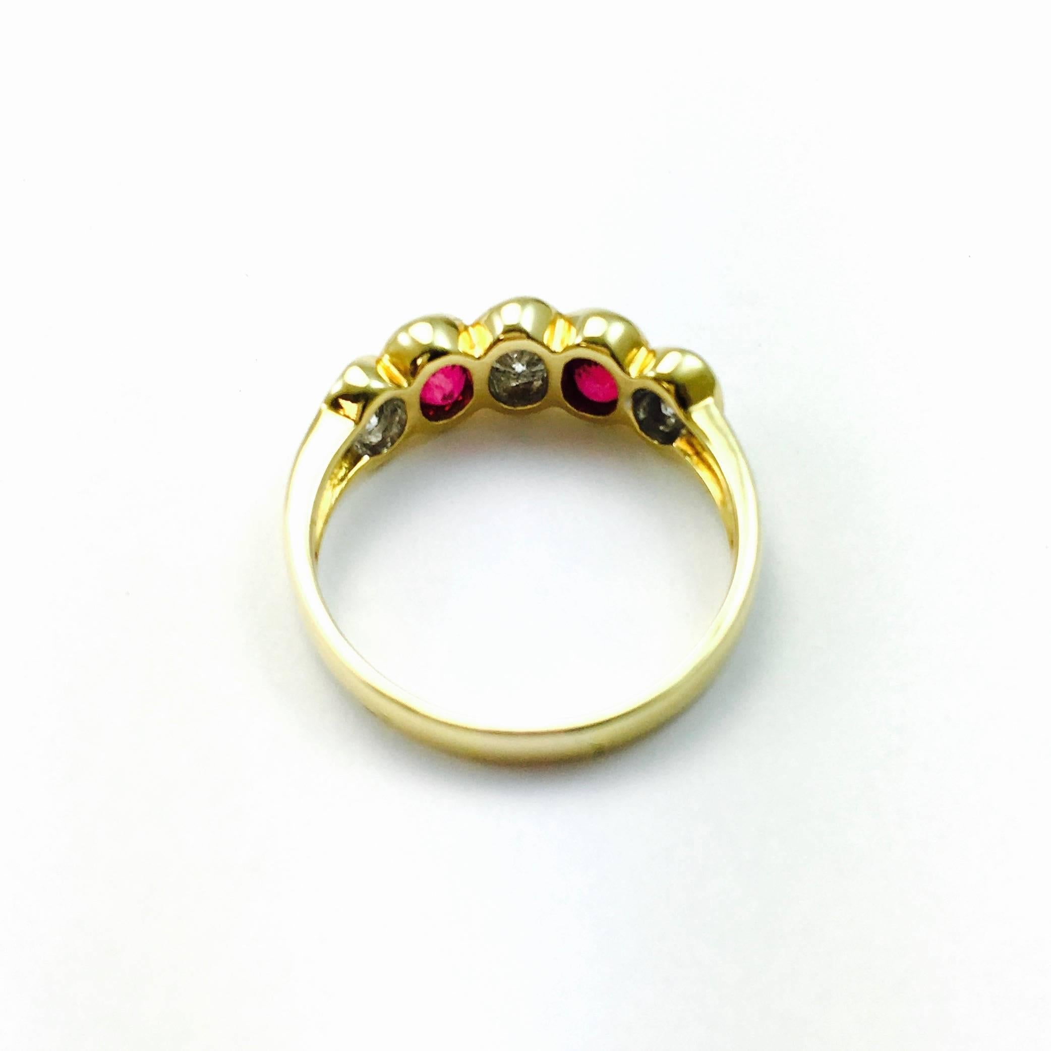 Simple but elegant five stone band from Damiani in 18K yellow Gold. Featuring gorgeous alternating  oval bezel set diamonds and rubies. 
3 diamonds: approximate total weight of 0.70 ct. Color: F-G, Clarity: VS
2 rubies: approximate total weight of