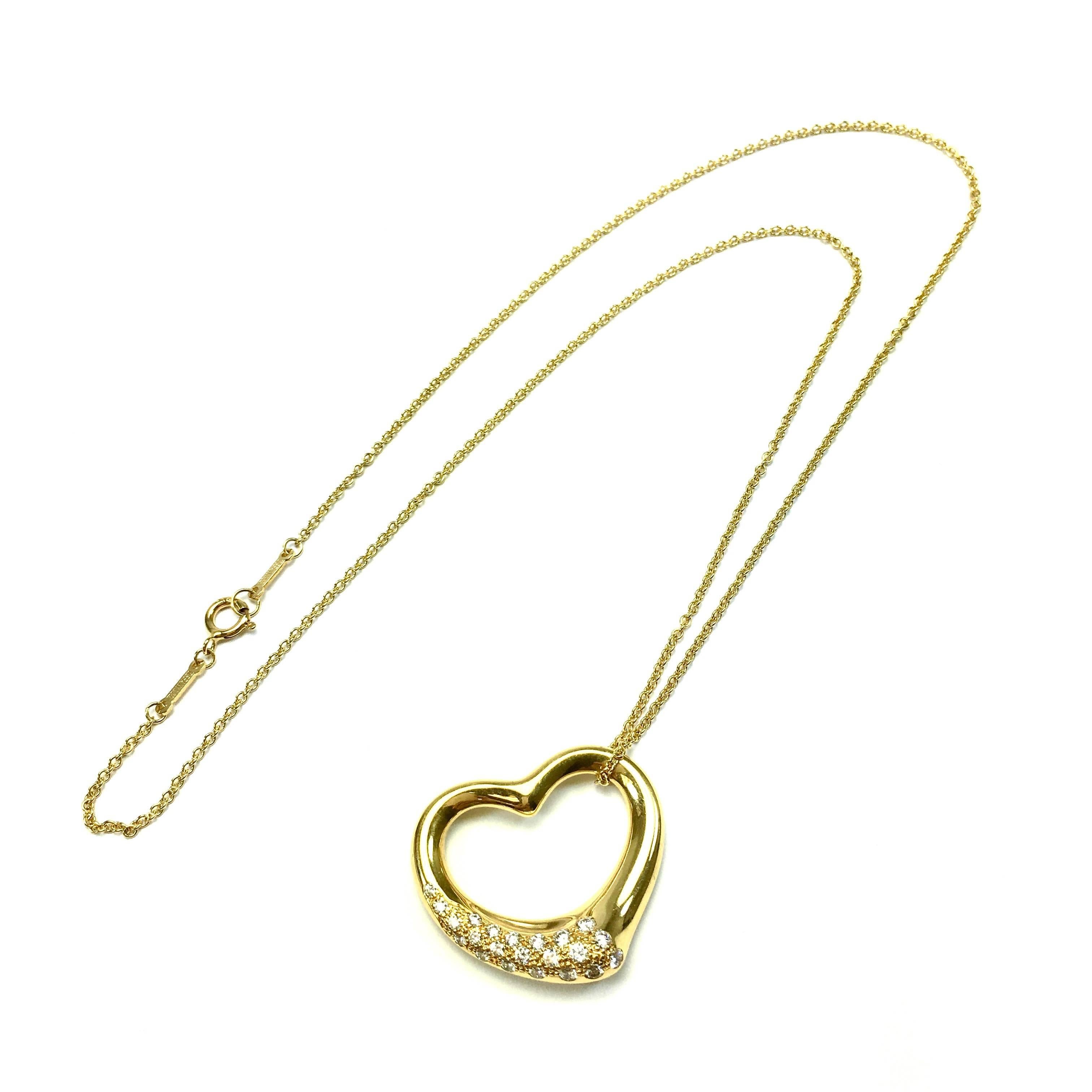 Elsa Peretti's most celebrated icon. Open heart pendant with pavé diamonds in 18K yellow gold on a 18